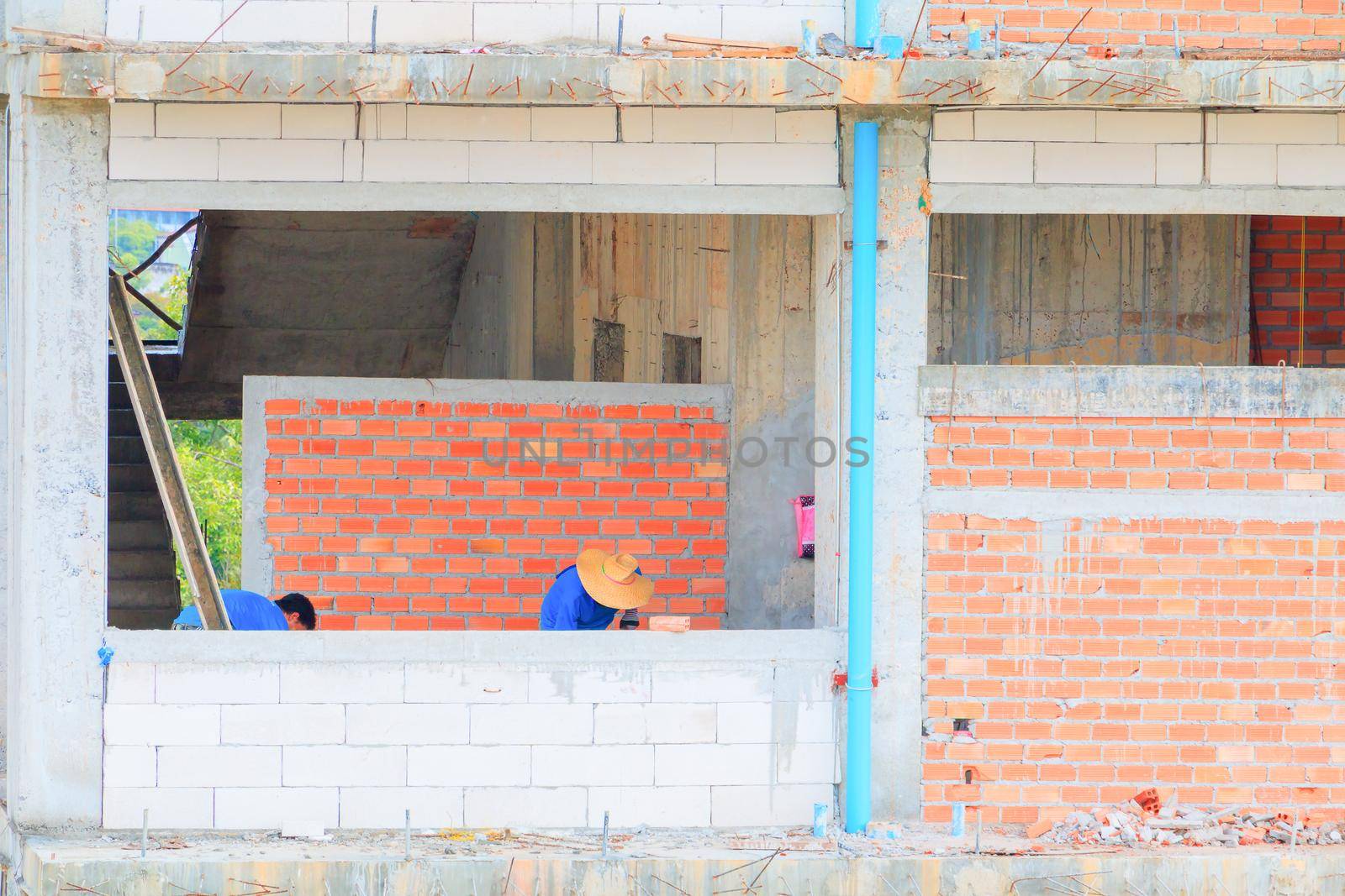 construction workers building develop of housing at laborer work outdoor. by pramot