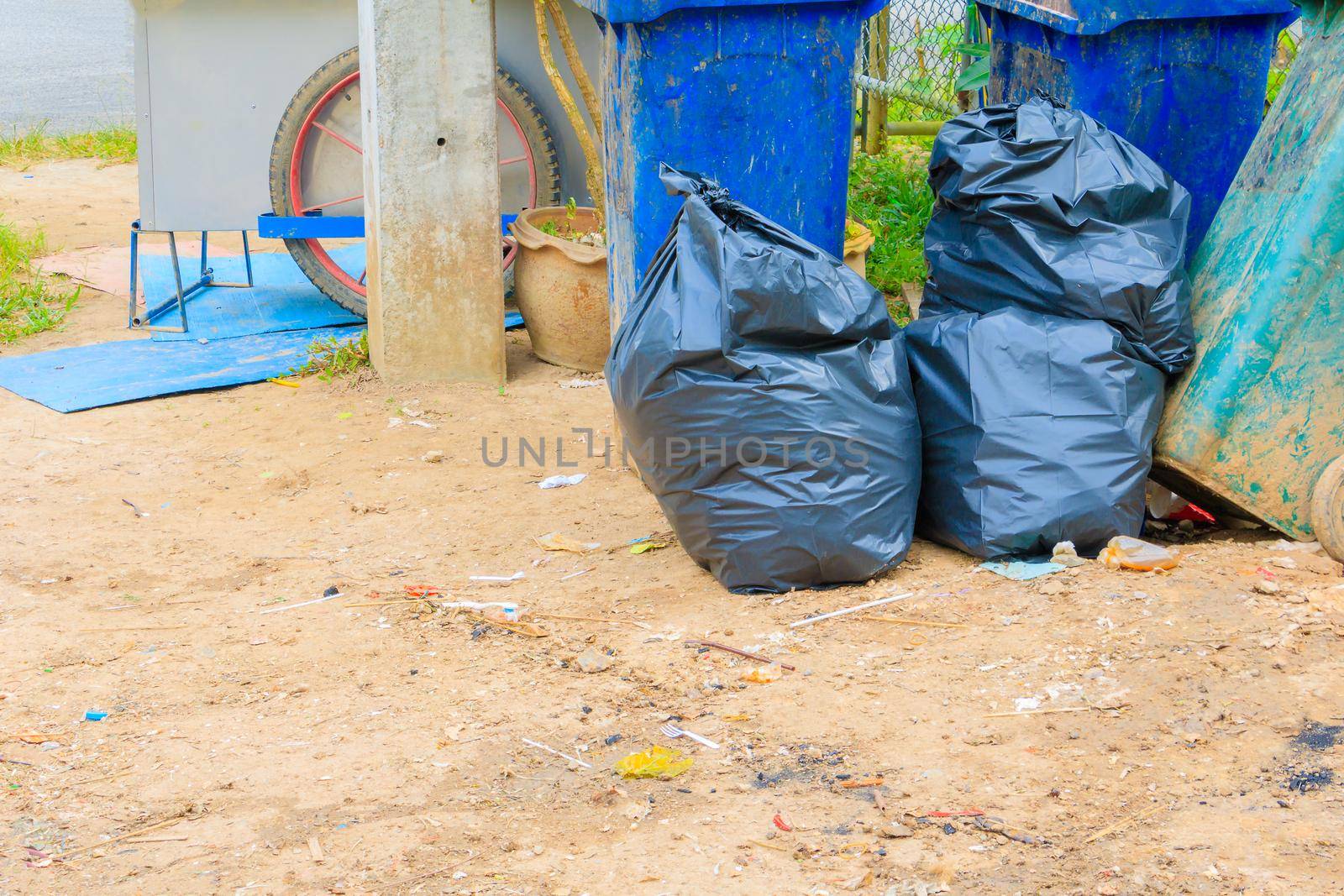 pile black garbage bag plastic and four dustbin dirty roadside in the city with copy space add text by pramot