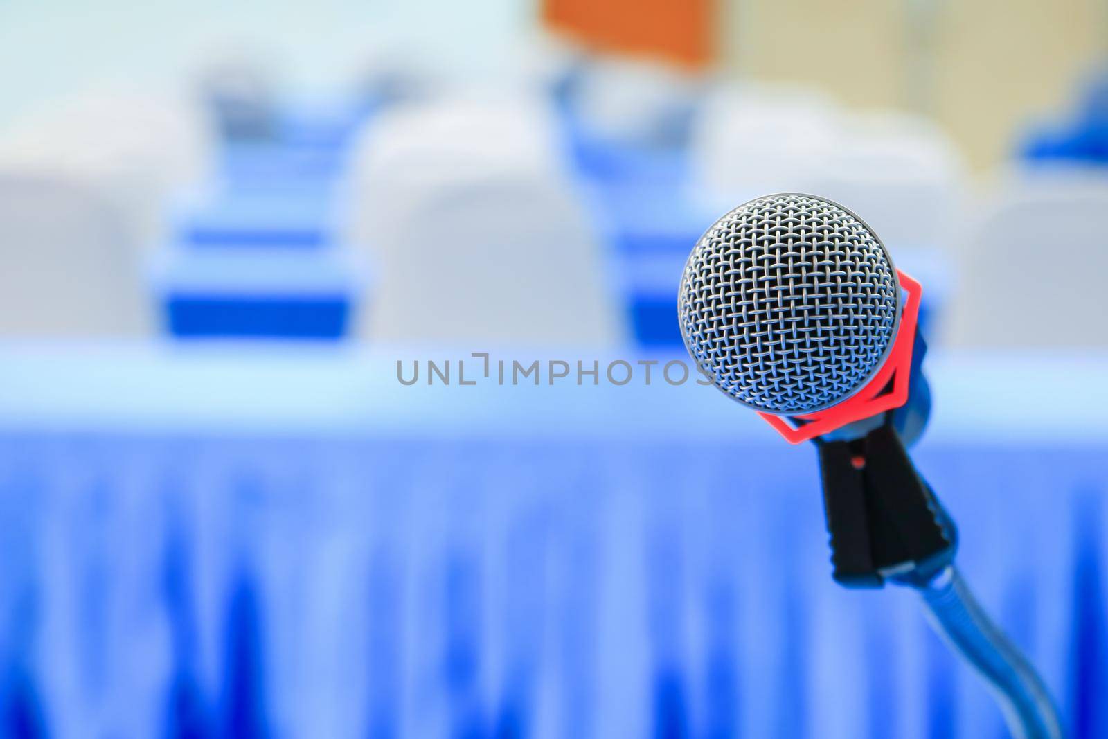 microphone wireless on a stand in interior meeting room seminar empty conference background: Select focus with shallow depth of field. by pramot