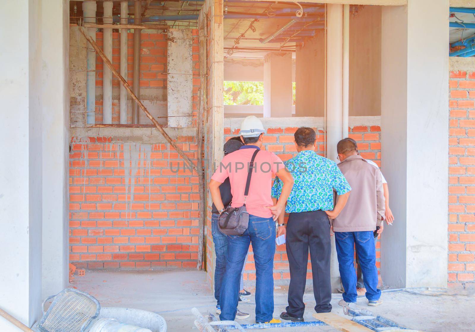 construction site and engineer check build plan development on housing High rise building by pramot