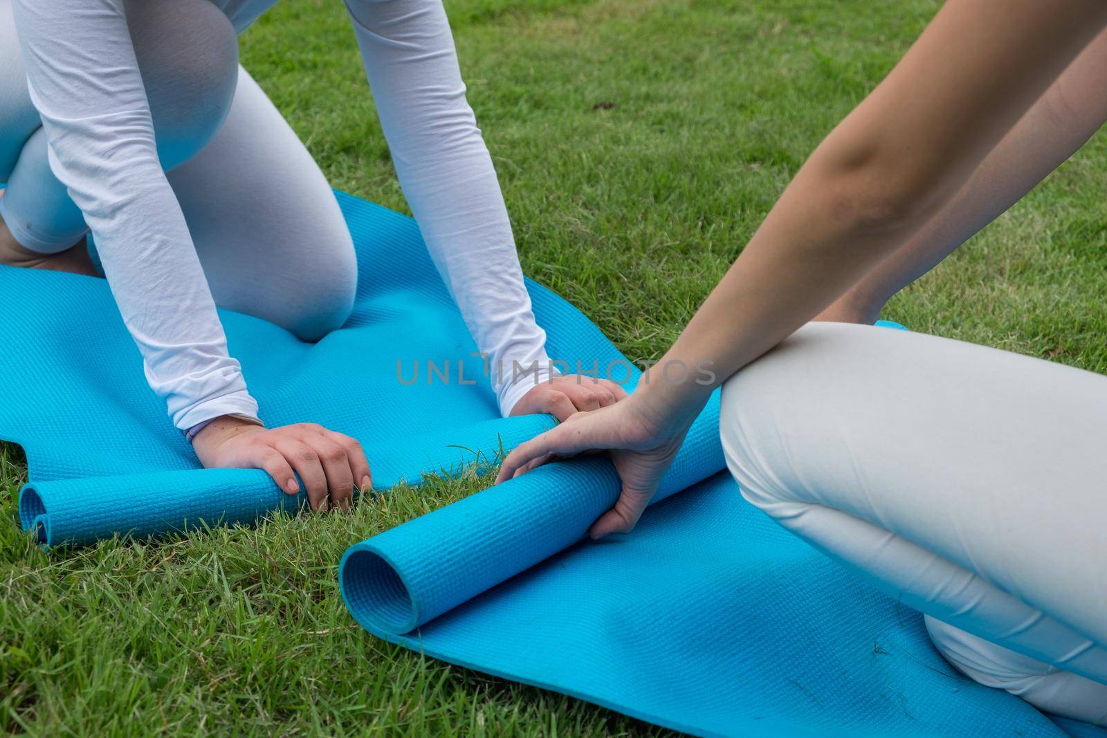 2 women keep yoga mat after Yoga class. by itchaznong