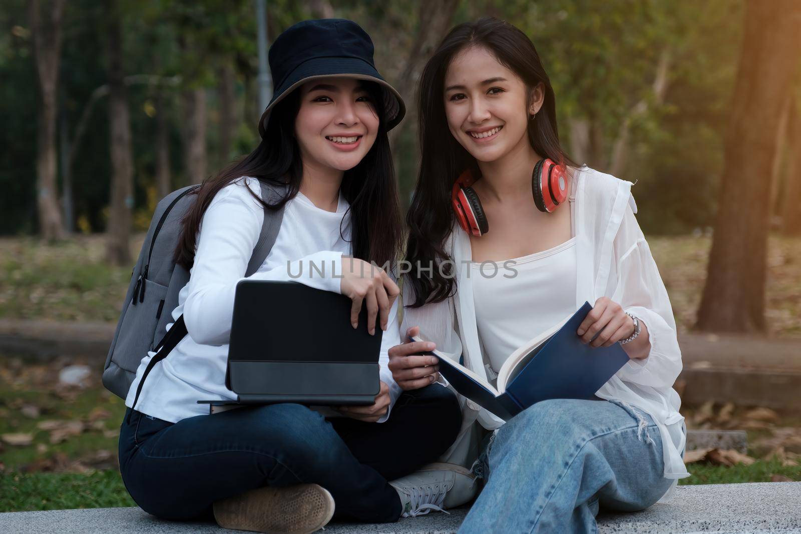 Friends or Family concept. Two Female using maps on tablet while travel
