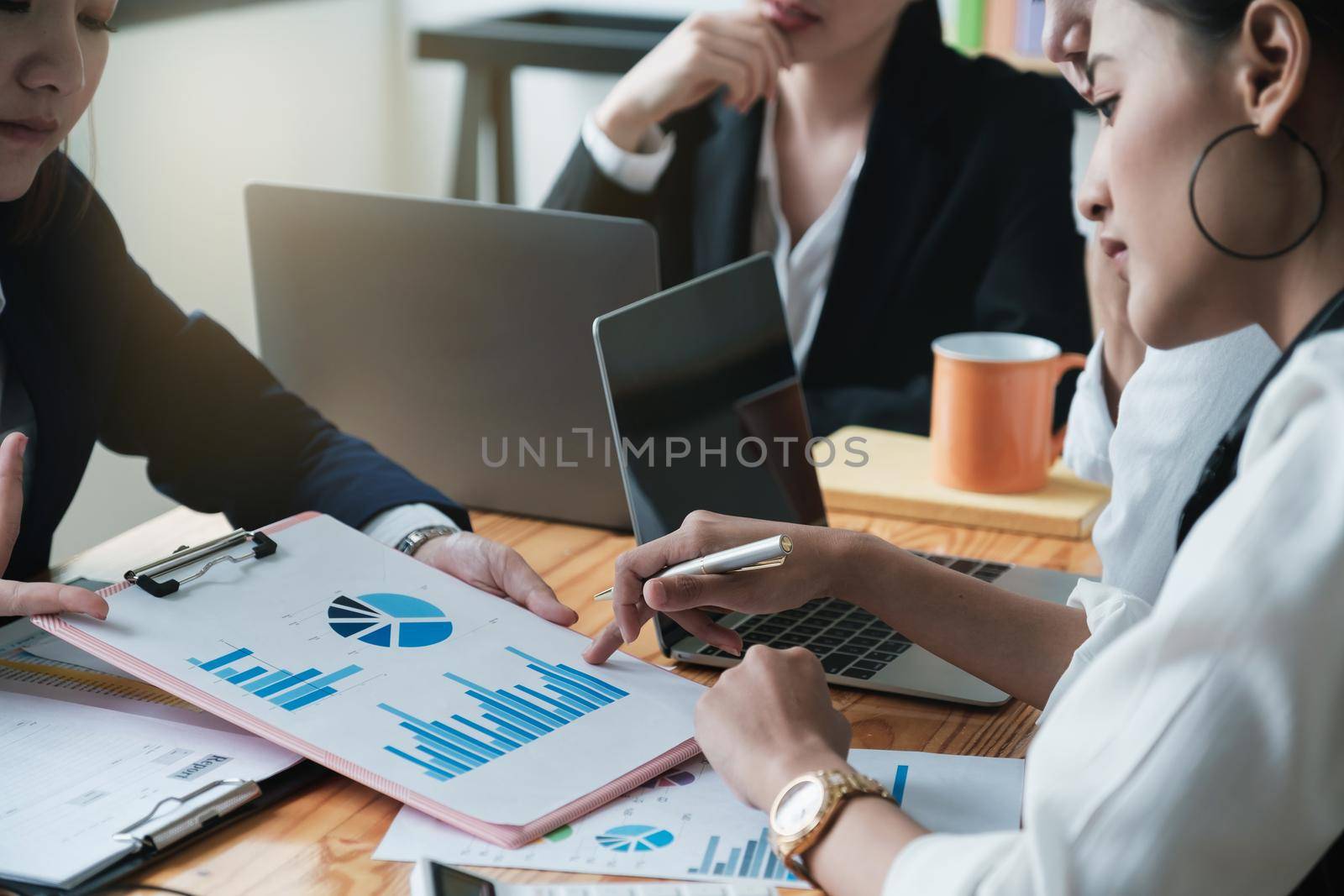 Group of people having business meeting discussion using laptop and data document during brainstorming