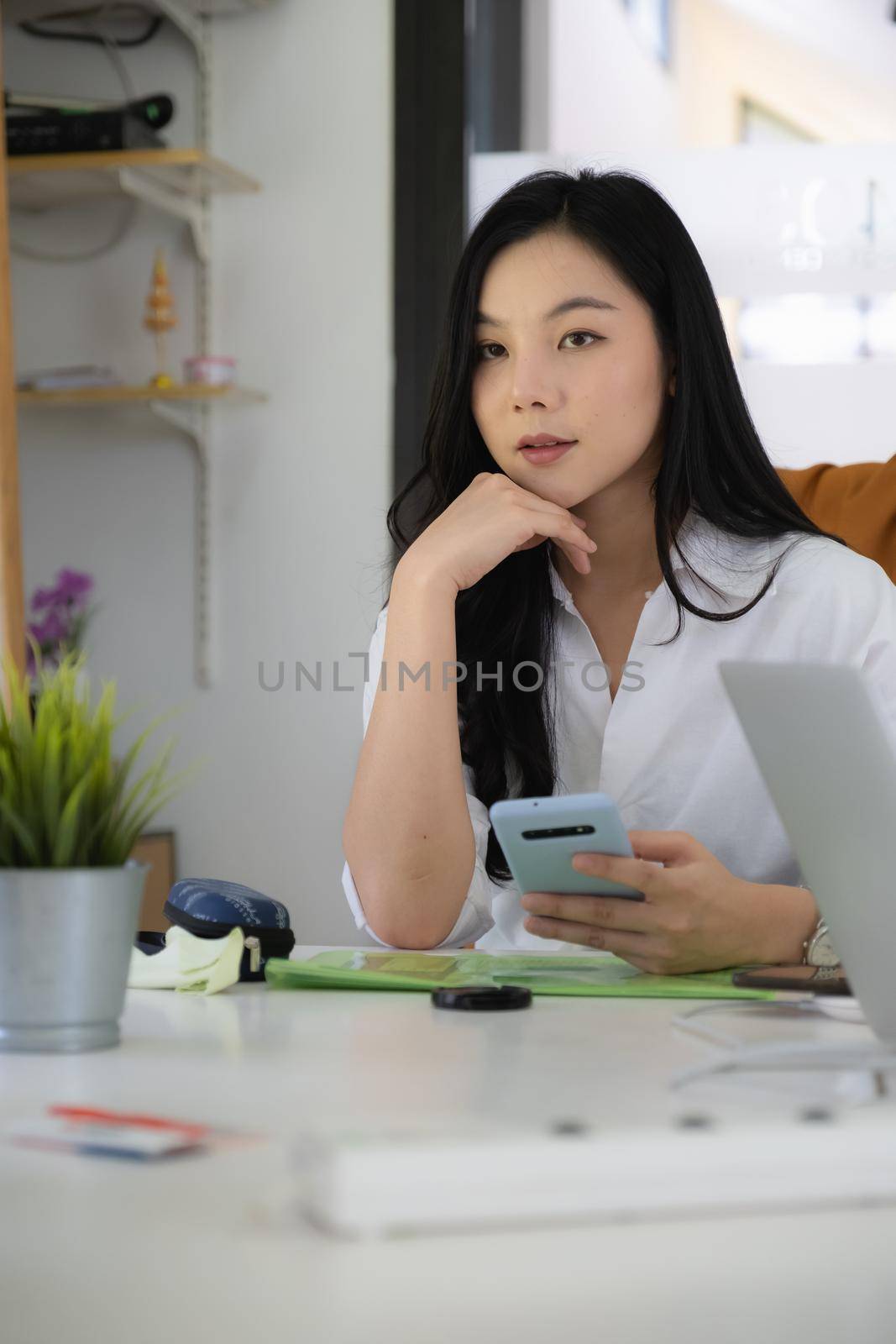 Portrait of Asian Business woman working from home. Accounting concept. by itchaznong