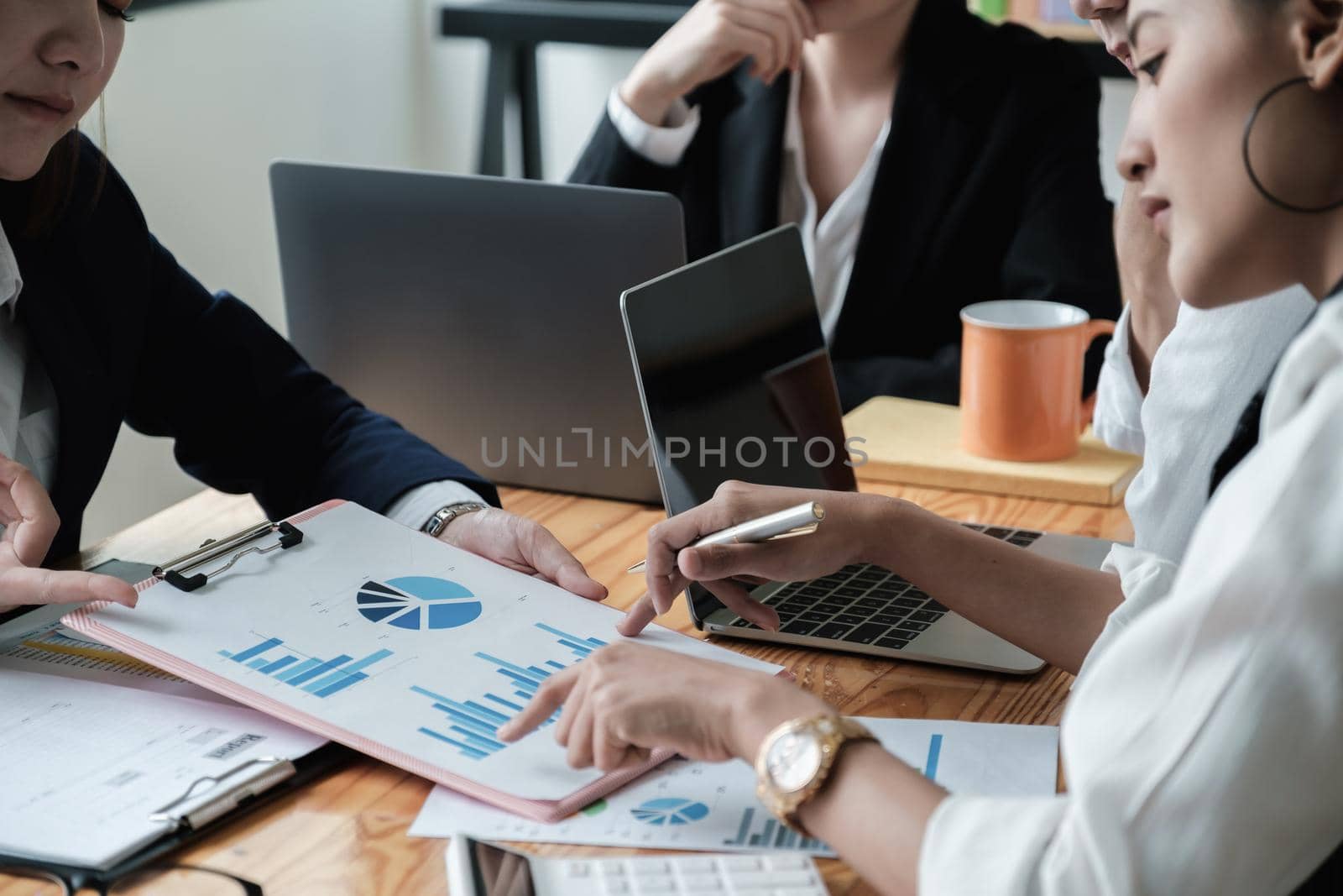 Close up Business woman and partner using calculator and laptop for calculating finance, tax, accounting, statistics and analytic research, group support and meeting concept.