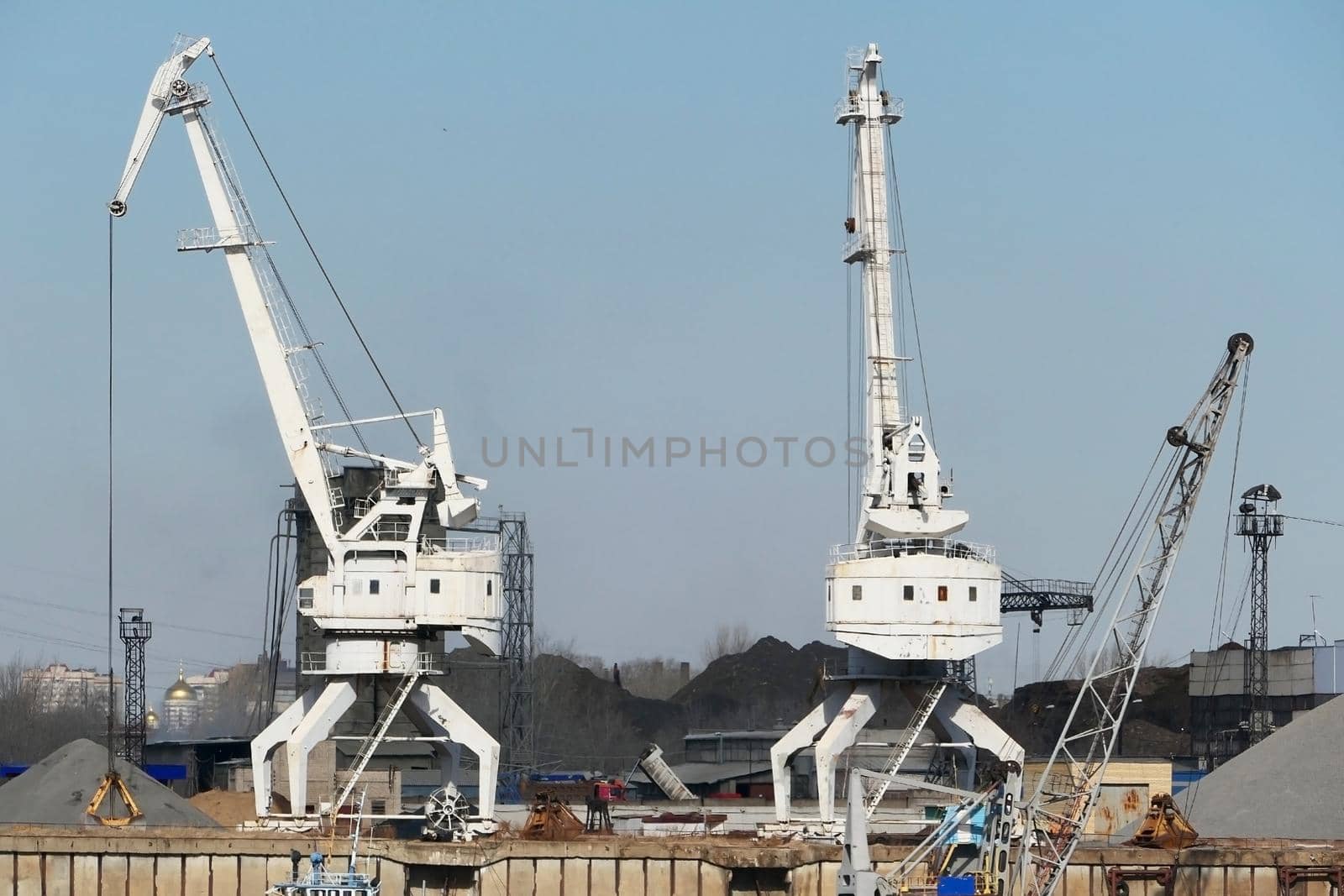 River port. The factory by the river. Sand mining. A crane and special equipment for loading sand. by Olga26