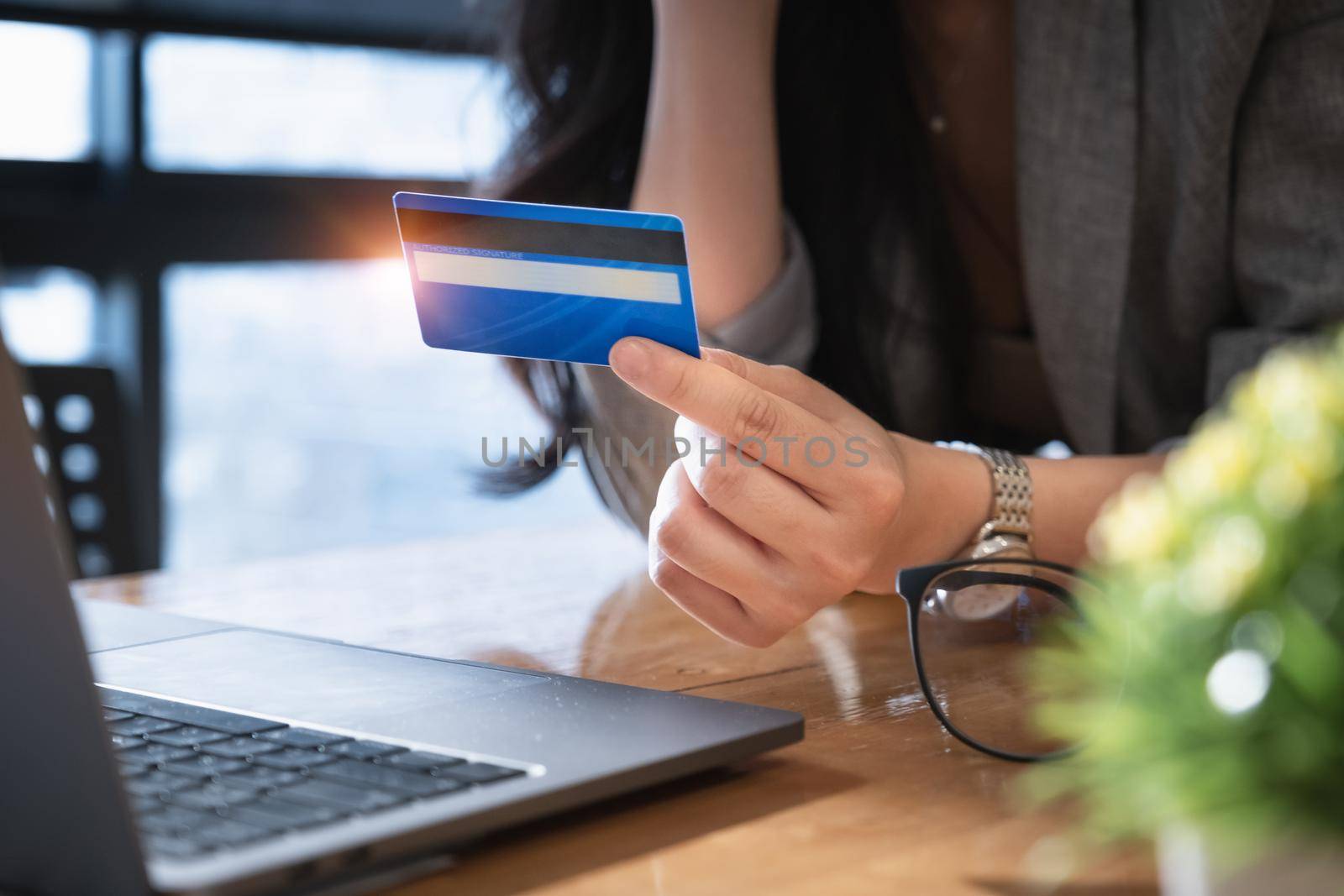 Online Shopping. Asian woman holding credit card and choose some online store