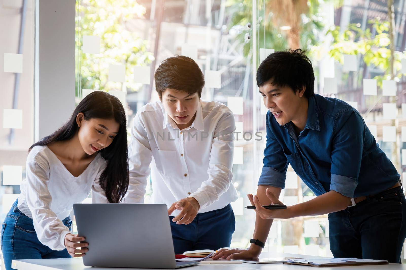 Analytics intelligence concept. Group of business people discuss current financial and economic on laptop for investment at the meeting. by itchaznong