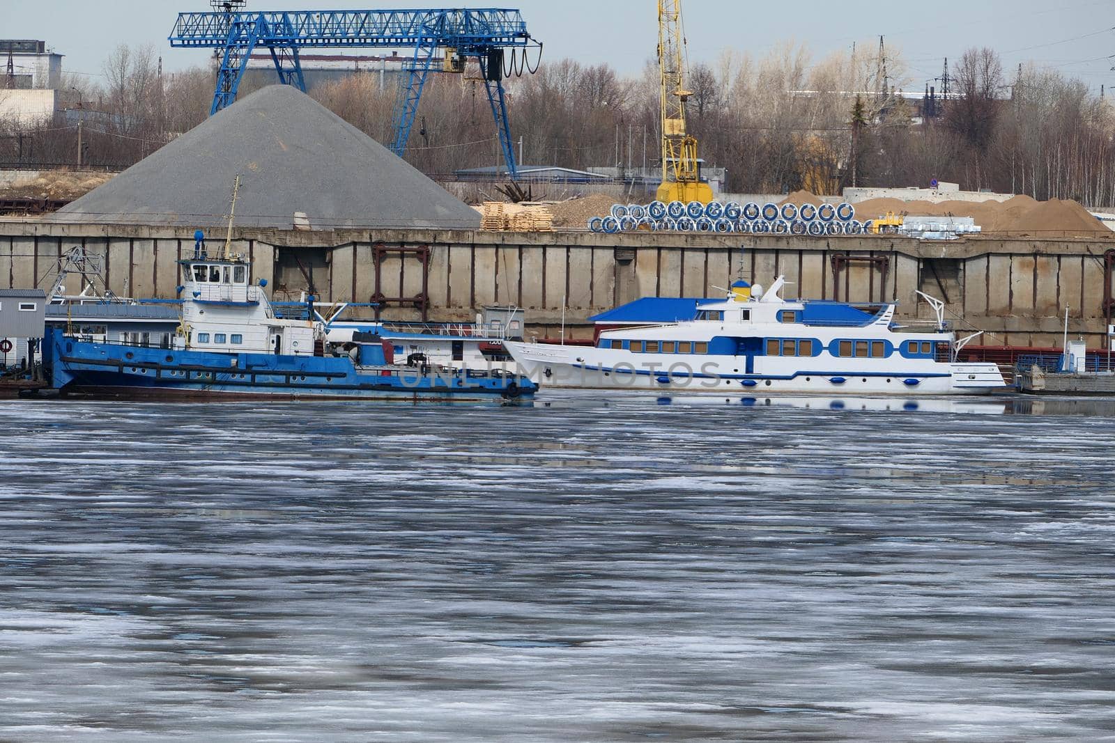 River port. The factory by the river. Sand mining. A crane and special equipment for loading sand. by Olga26