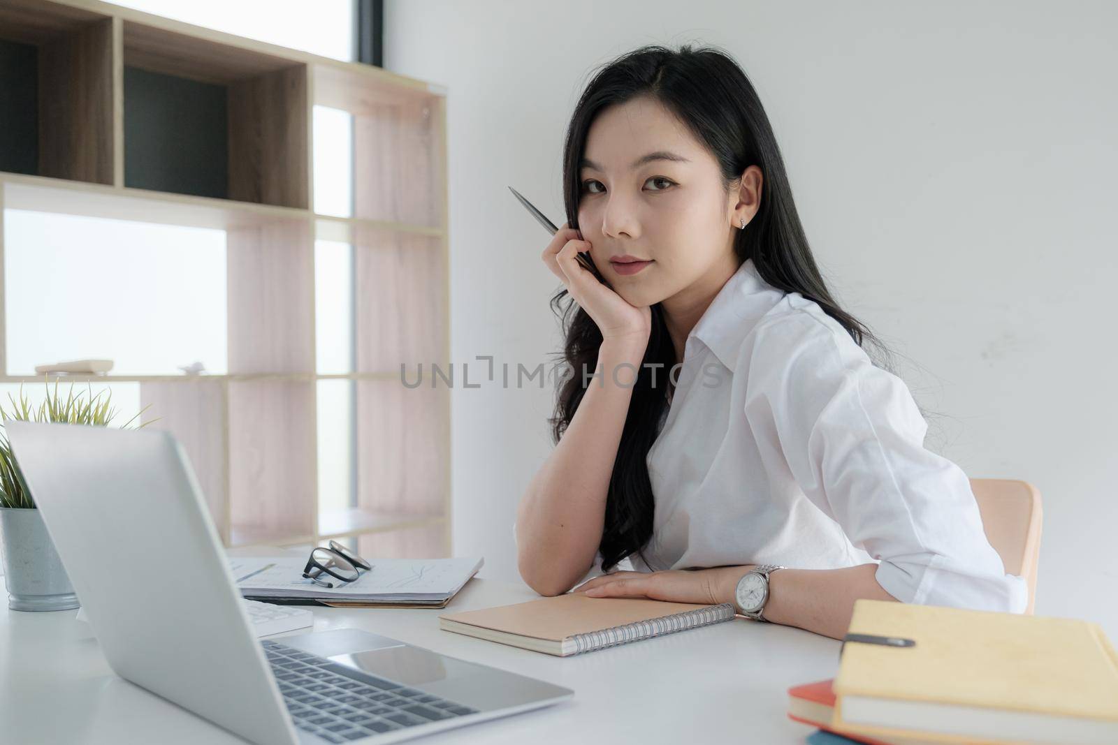 Portrait of Asian Business woman working from home. Accounting concept. by itchaznong