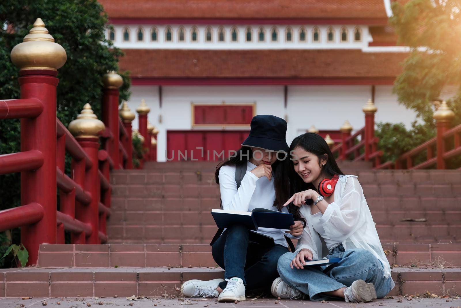 Two Young students campus learning tutoring with friend after class stop. Study, education, university, college, graduate concept. by itchaznong