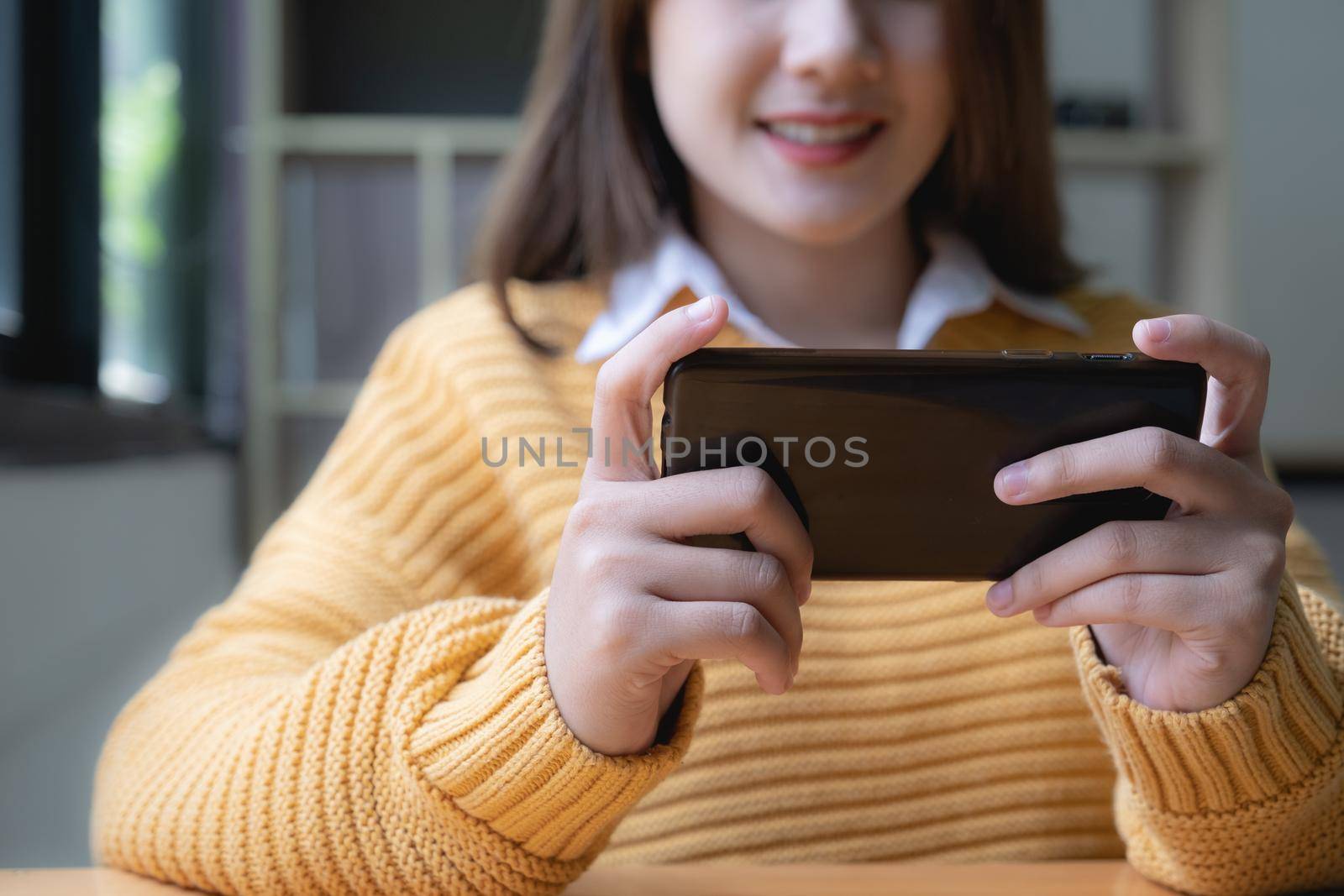 Young asian woman surprised by unbelievable good news, fantastic online travel offer looking at smartphone