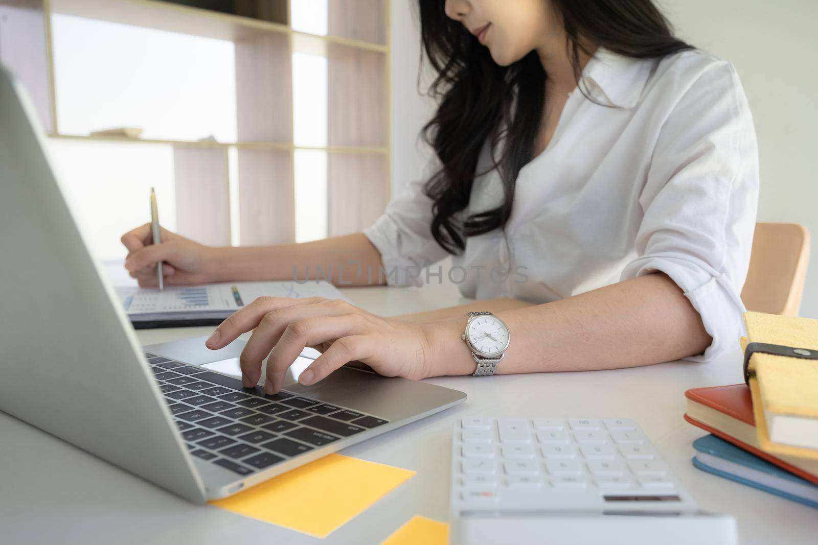 Portrait of Asian Business woman working from home. Accounting concept by itchaznong