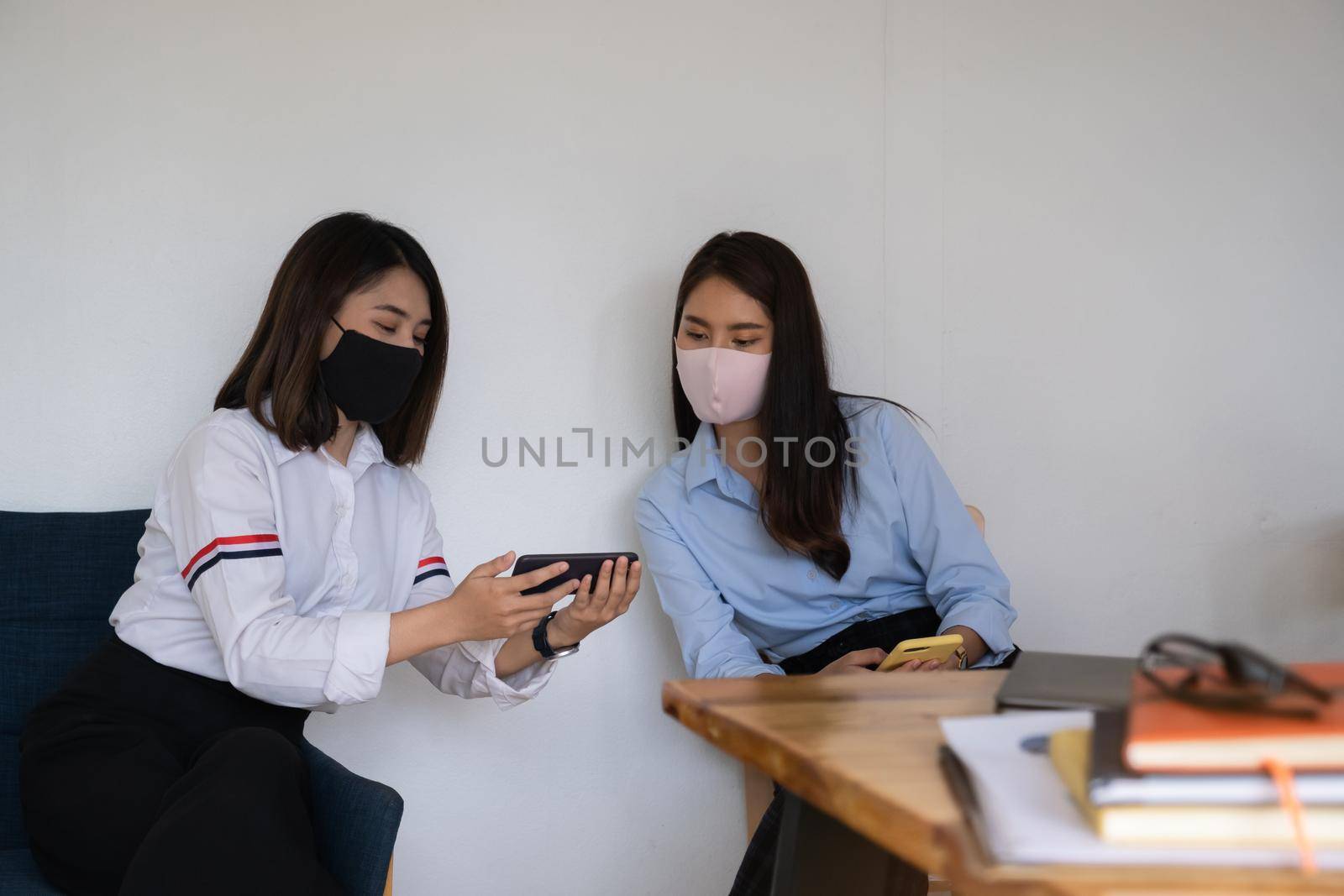 Young student watching electronic breaking news on smartphone in classroom