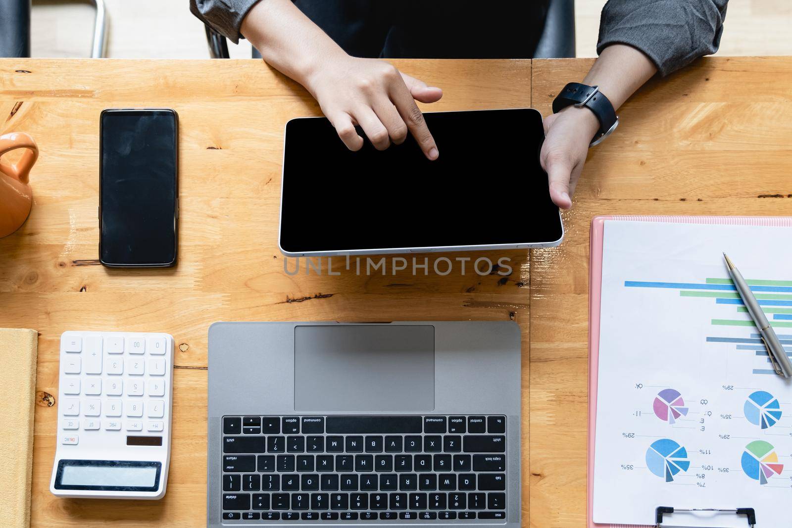 Asian Woman Fund managers analyzing results of research Investment stock market by digital tablet