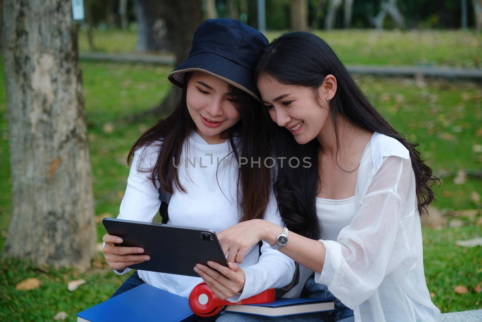 Friends or Family concept. Two Female using maps on tablet while travel
