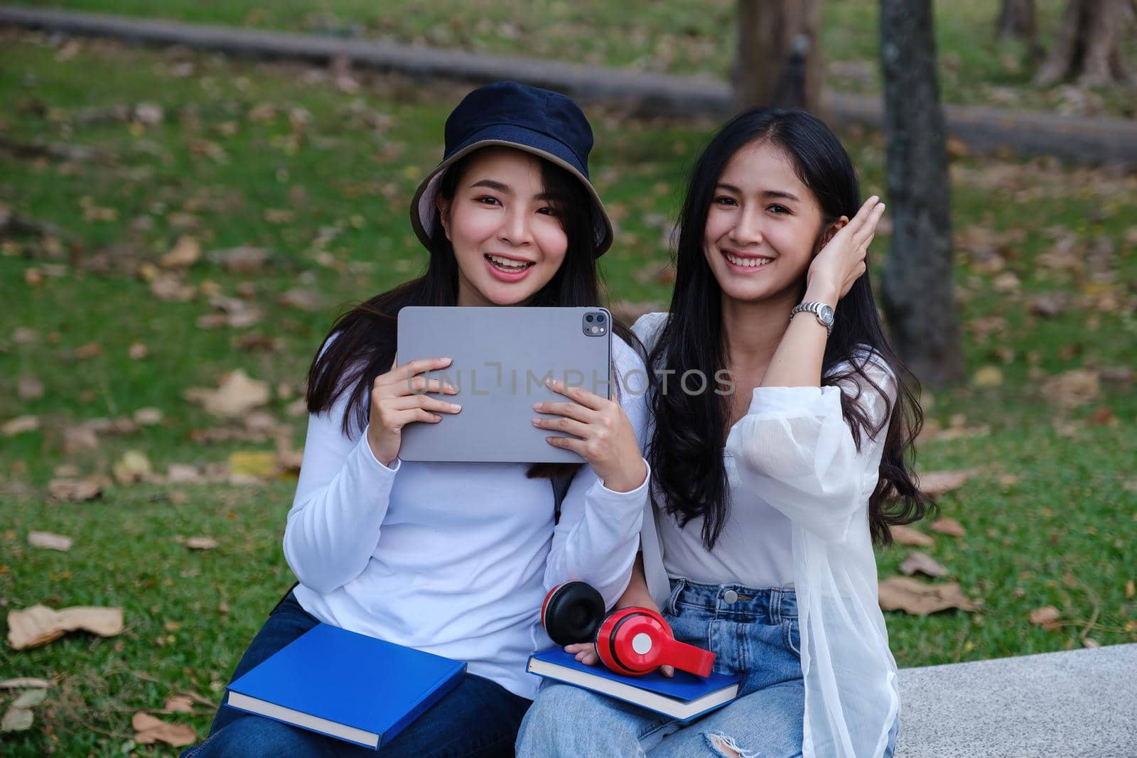 Two students are sitting in university during break and communication. Study, education, university, college, graduate concept