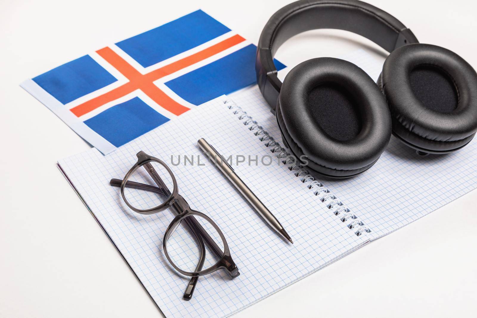 Learning foreign languages in Iceland with audio recordings and headphones. Notepad, glasses, pen.