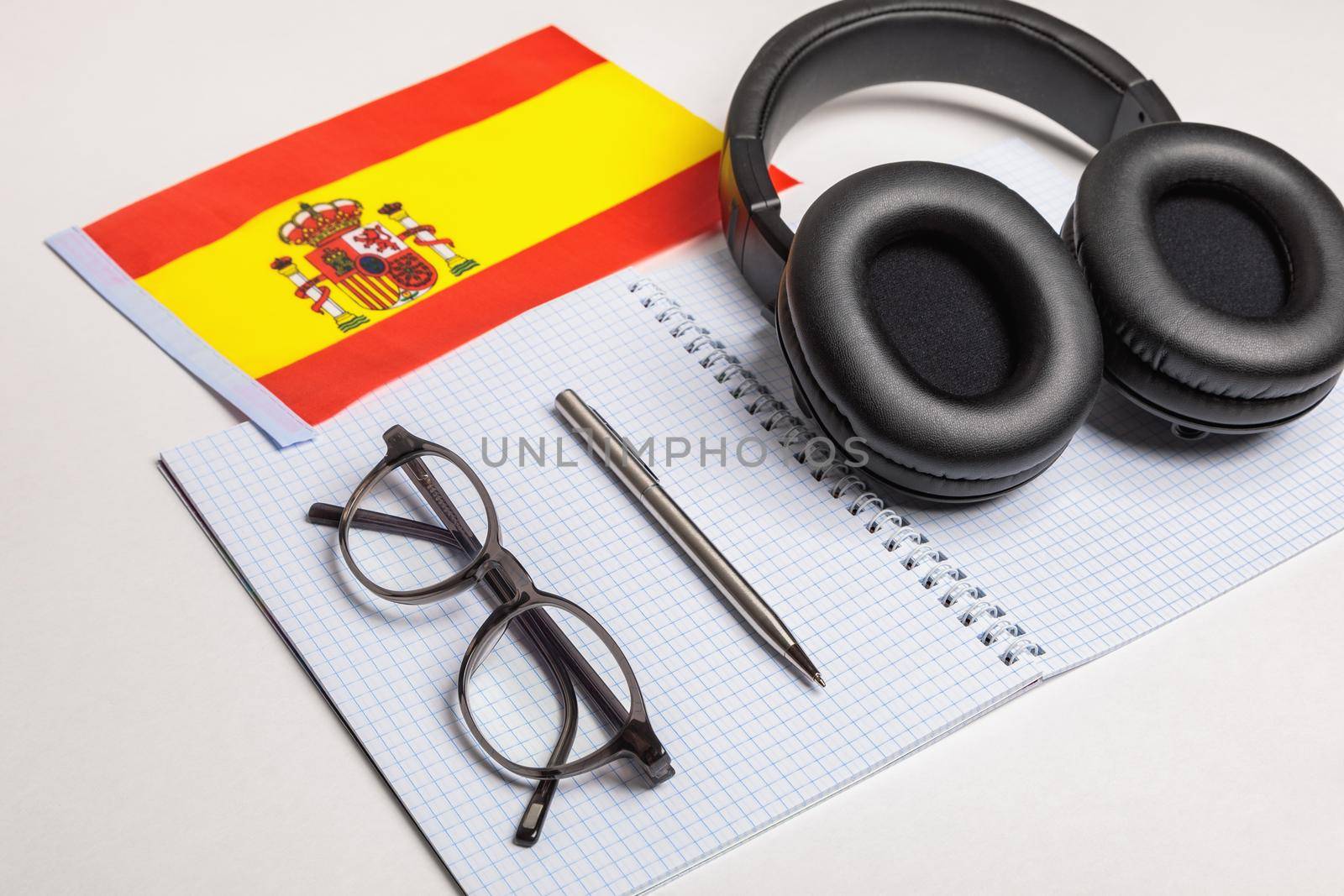 Learning foreign languages in Spain with audio recordings and headphones. Notepad, glasses, pen.