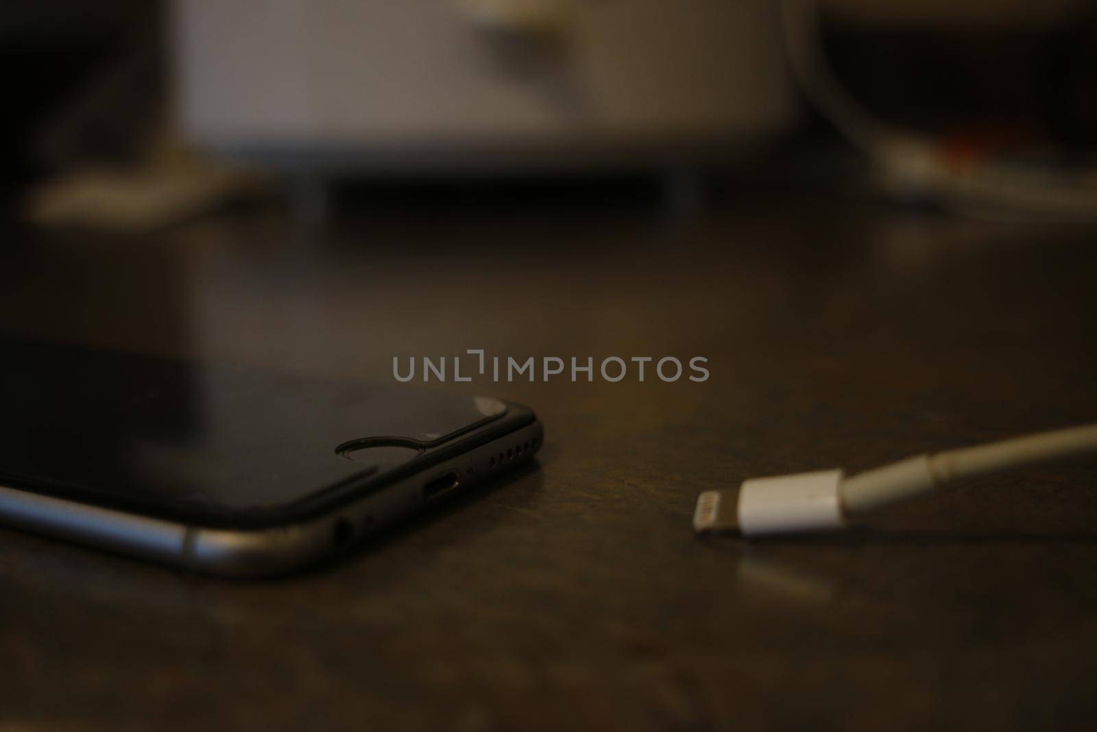 London Canada, September 22 2019: Editorial photograph of an iPhone 6 next to a charging cable. Apple has created the most popular phone in the world..