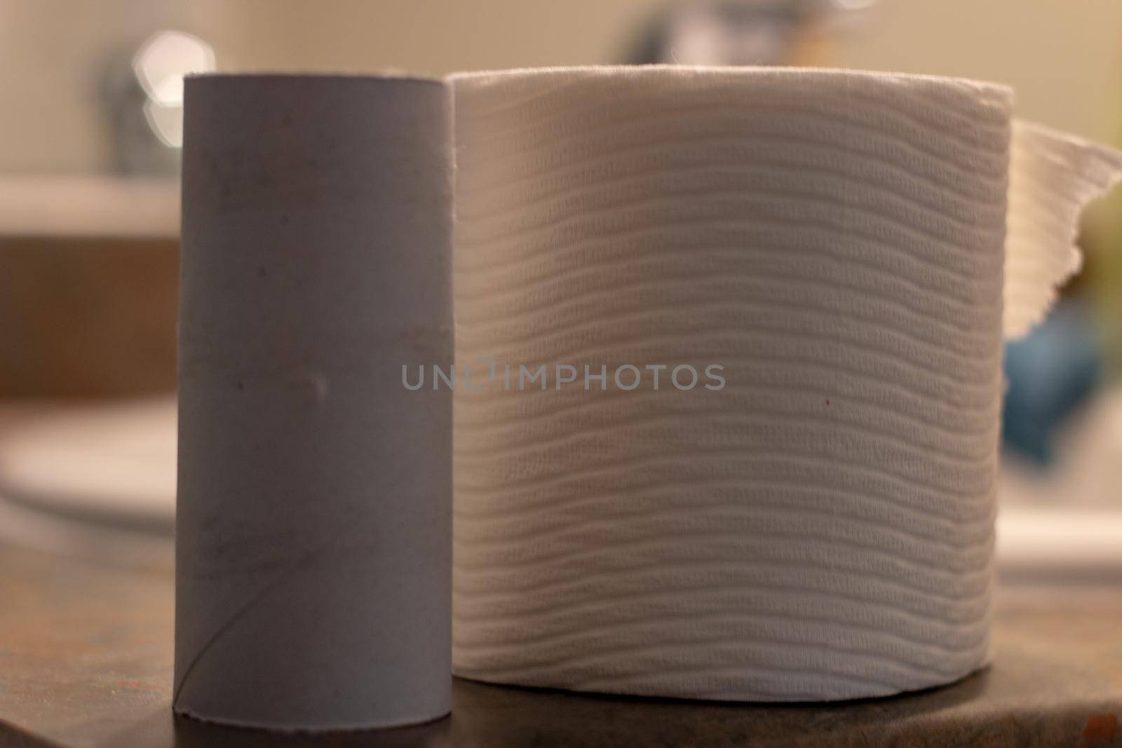 Three rolls of white toilet paper, isolated on white background.