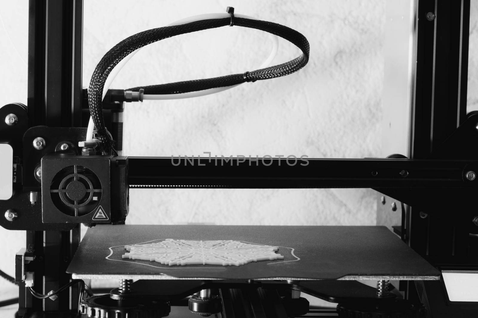 Snowflake printing on a 3D printer, 3D print details. Black and white image.