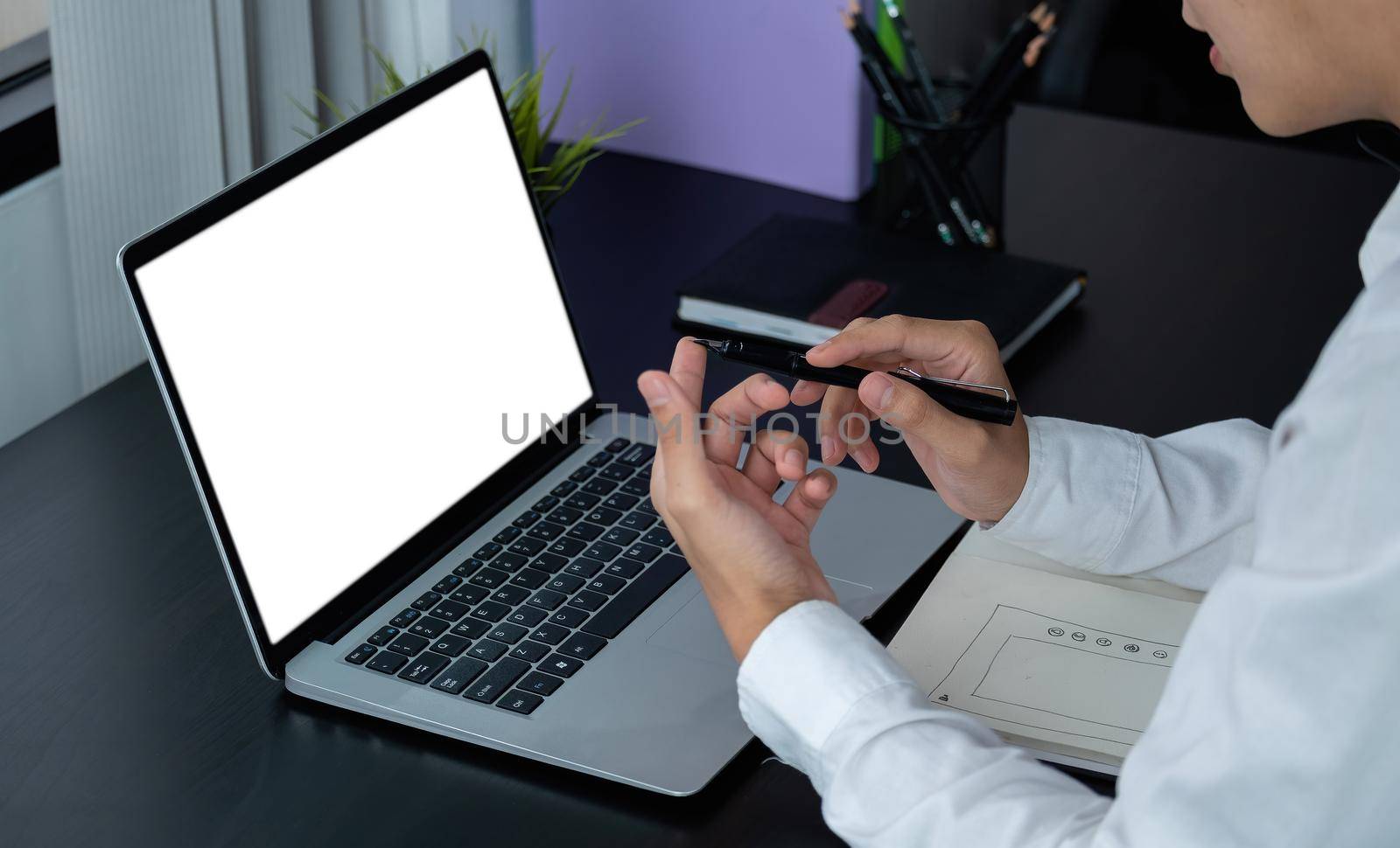 young man wearing headphones looking at laptop monitor, listening to educational lecture webinar, writing notes. Motivated millennial woman studying remotely in online university.