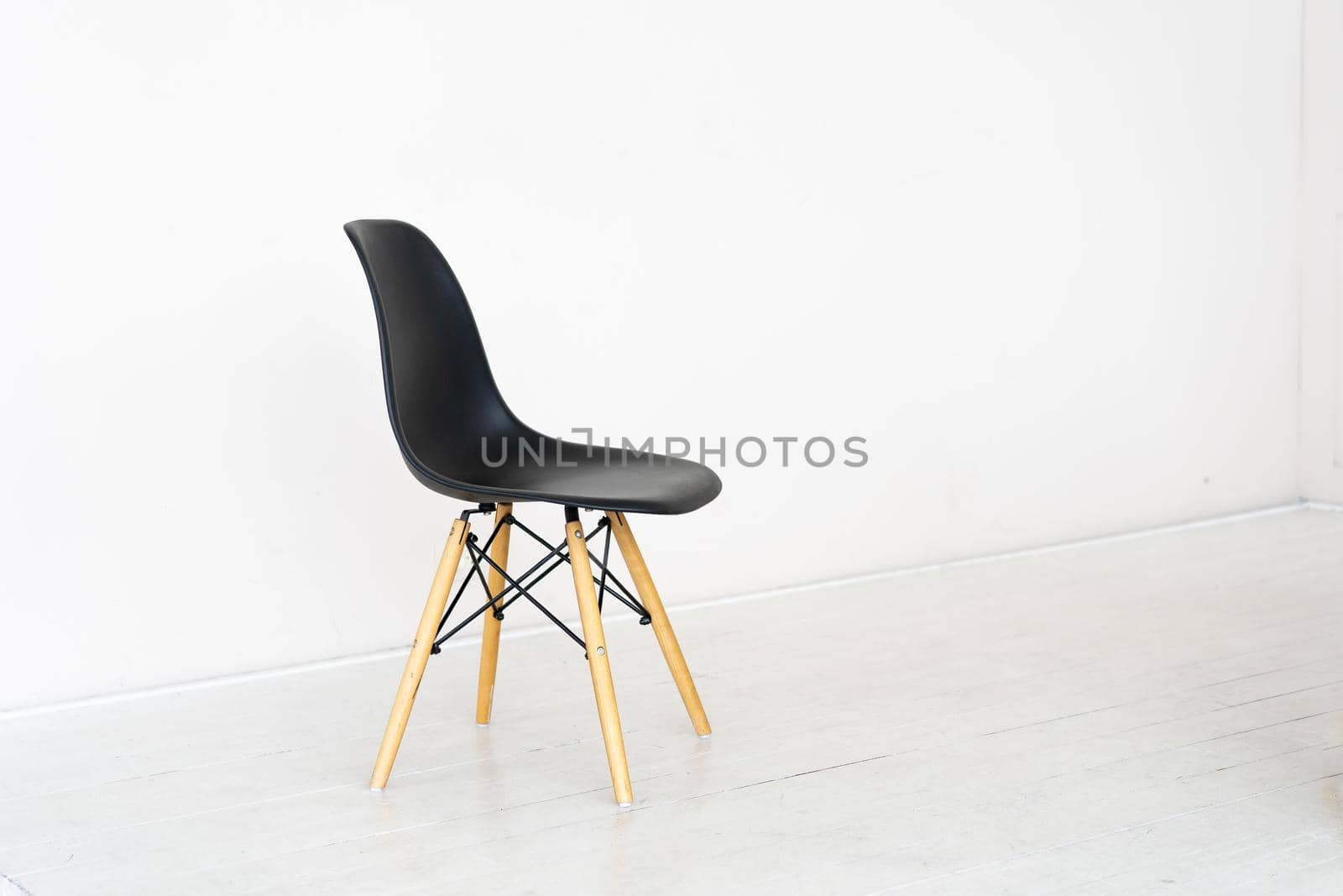 Black seat chair on white floor and white wall background Copy space for text Minimalism