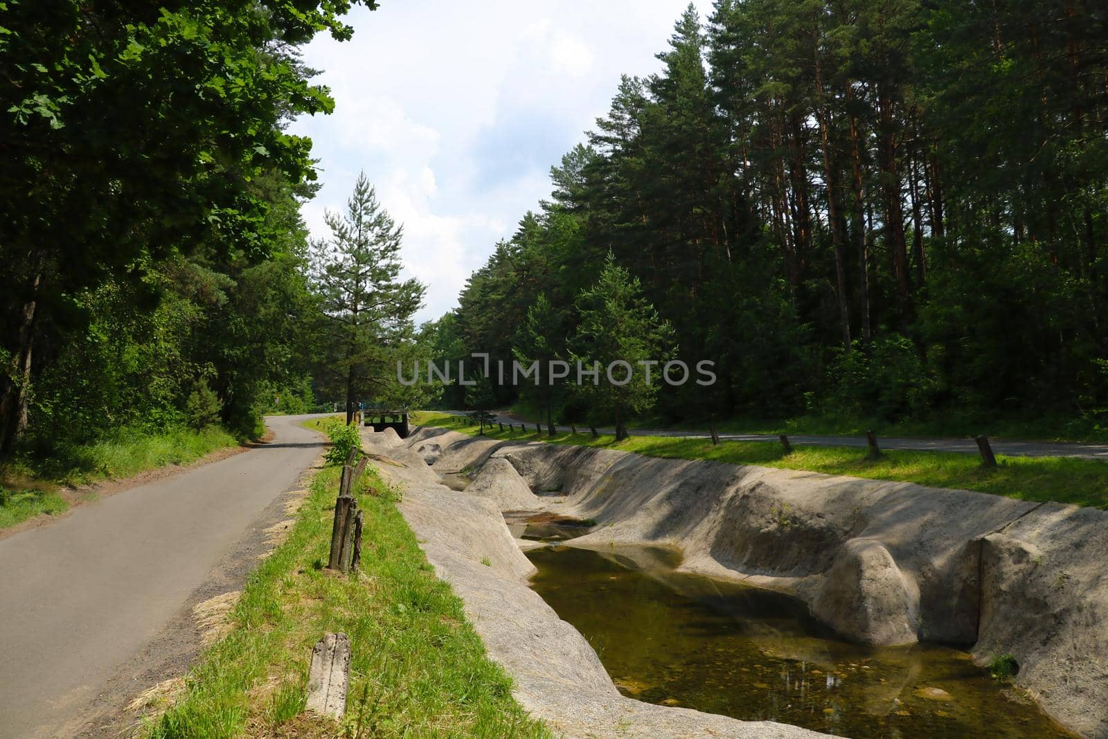 Empty artificial canal without water for sports in the forest