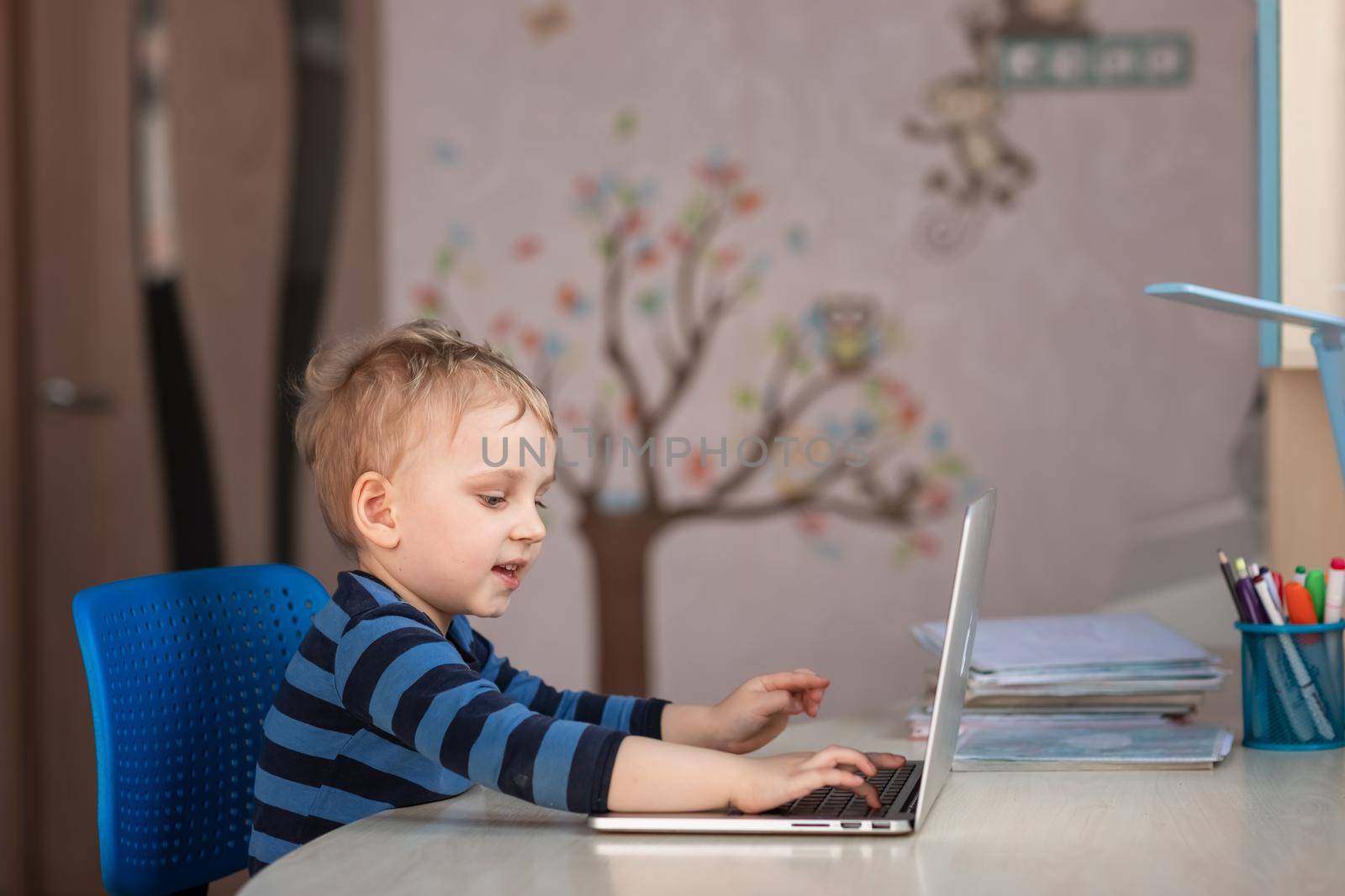 Cute baby boy having video class or video chat with grandparents. Quarantine isolation distance communication concept