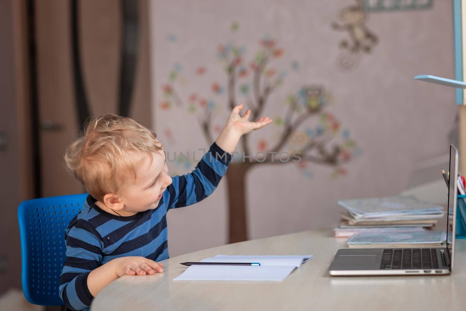 Cute baby boy having video class or video chat with grandparents. Quarantine isolation distance communication concept