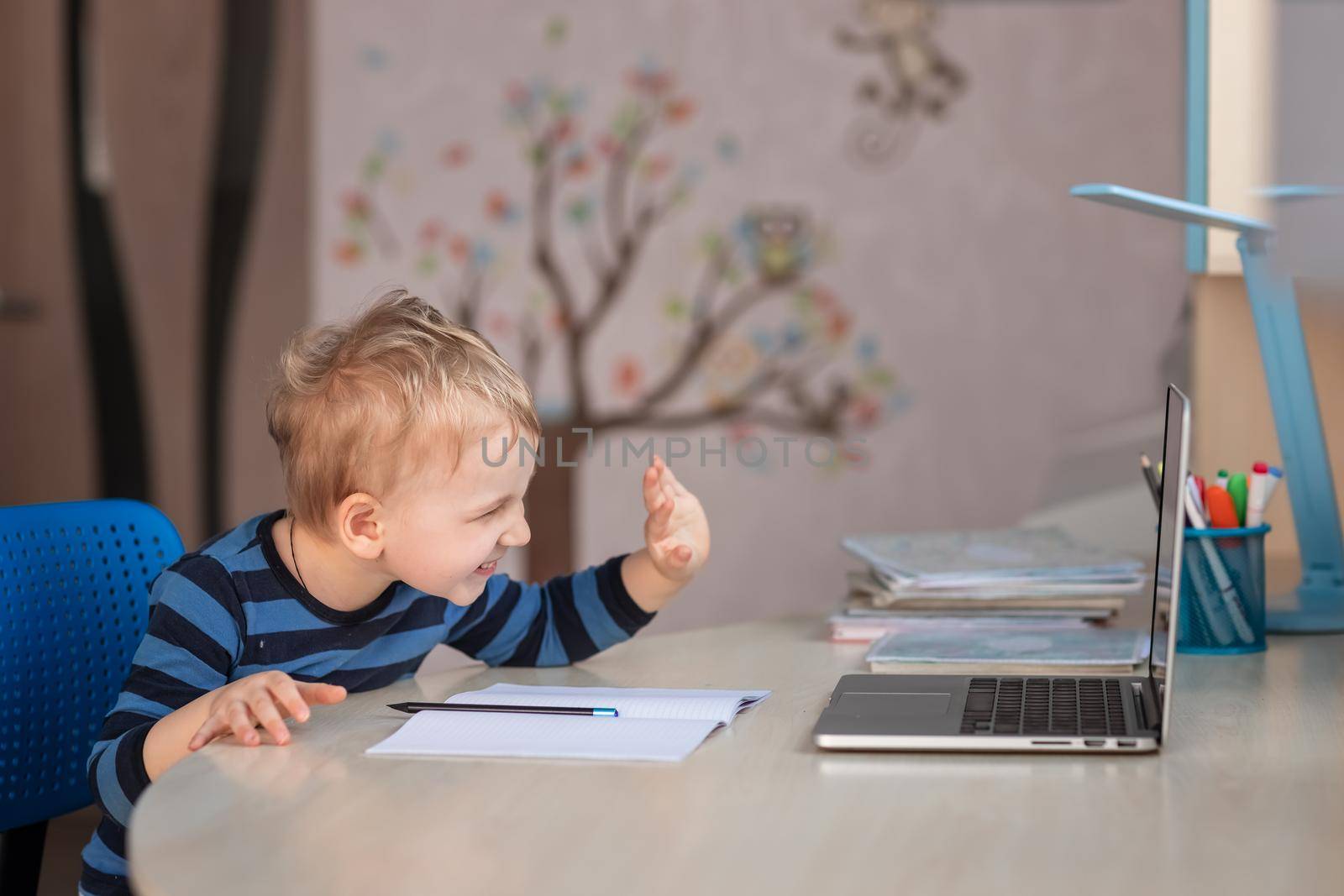 Cute baby boy having video class or video chat with grandparents. Quarantine isolation distance communication concept