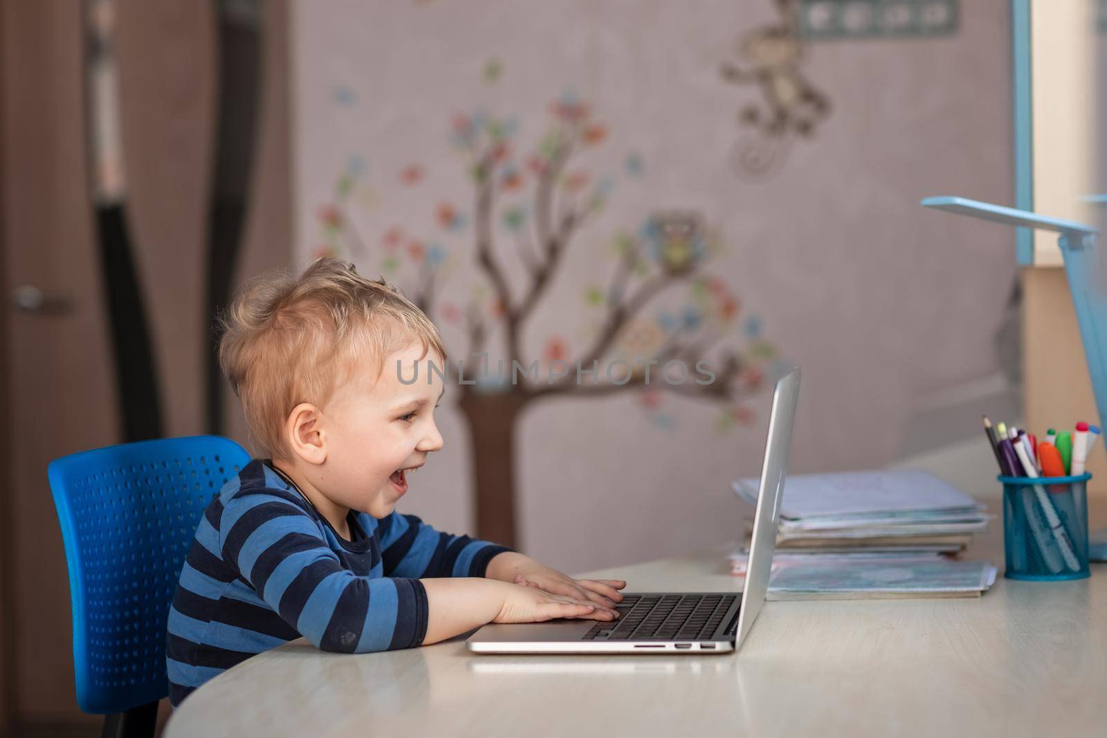 Cute baby boy having video class or video chat with grandparents. Quarantine isolation distance communication concept