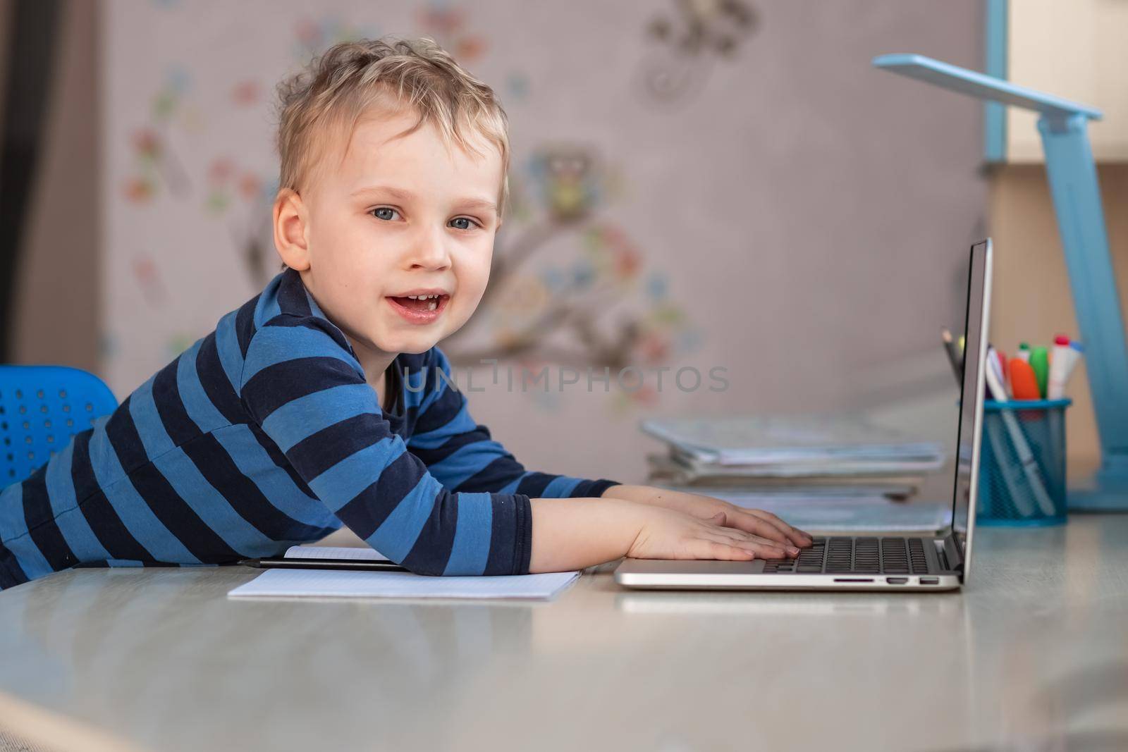 Cute baby boy having video class or video chat with grandparents. Quarantine isolation distance communication concept