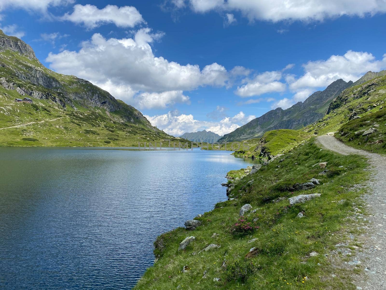 Footpath on the shore of the Lake Giglachsee in the Styrian Tauern - Austria. Lake Giglachsee in the Styrian Tauern - Austria. The place without  tourists after the coronavirus pandemic.