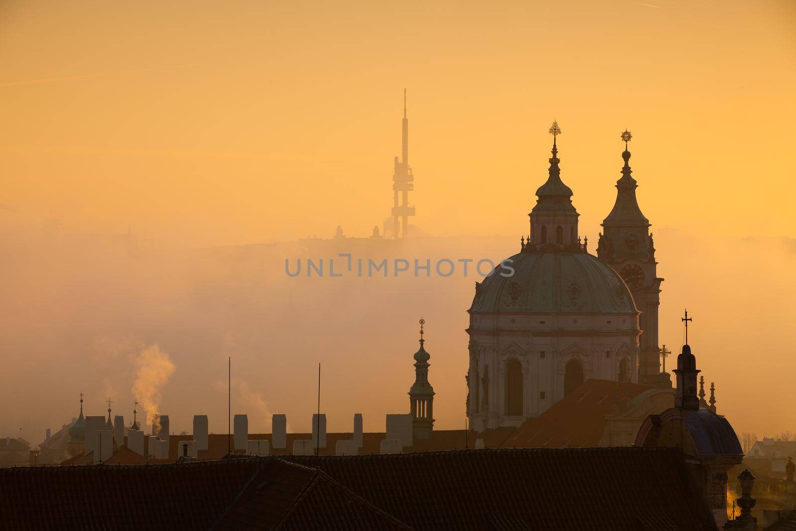 The Church of St.Nicholas in the mist. Prague, Czech Republic.This is the most famous Baroque church in Prague, stands along with the former Jesuit college in the centre of the Lesser Town Square.