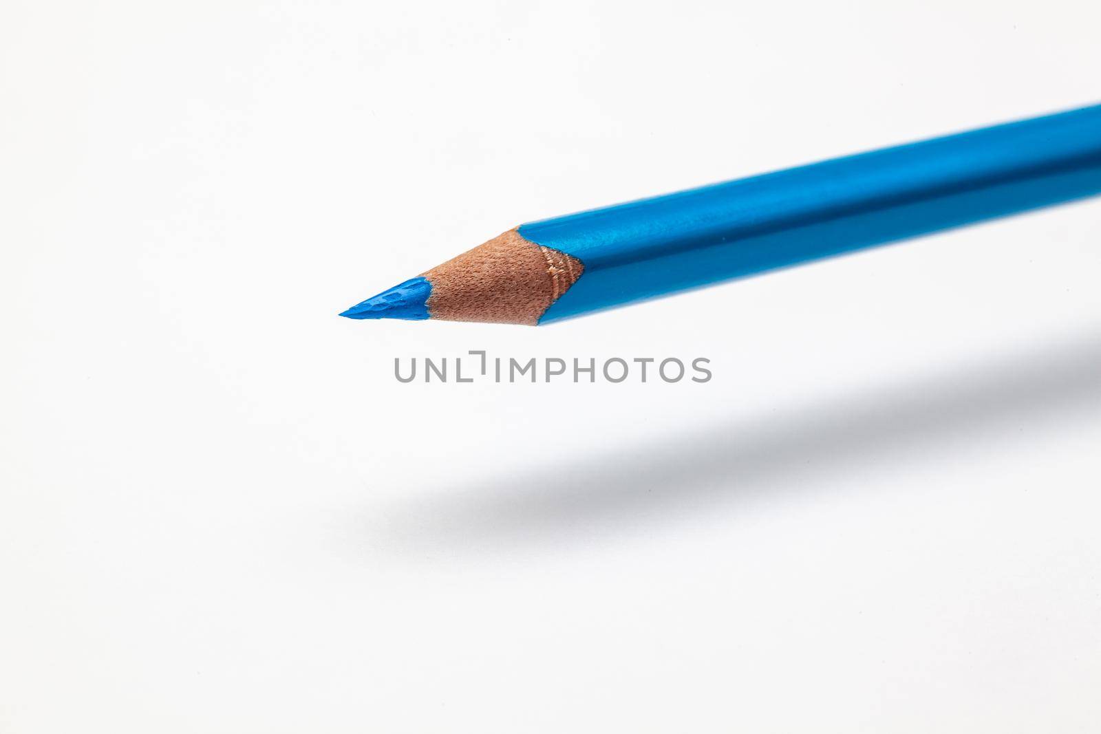 Levitating color pencil on the white office table.
