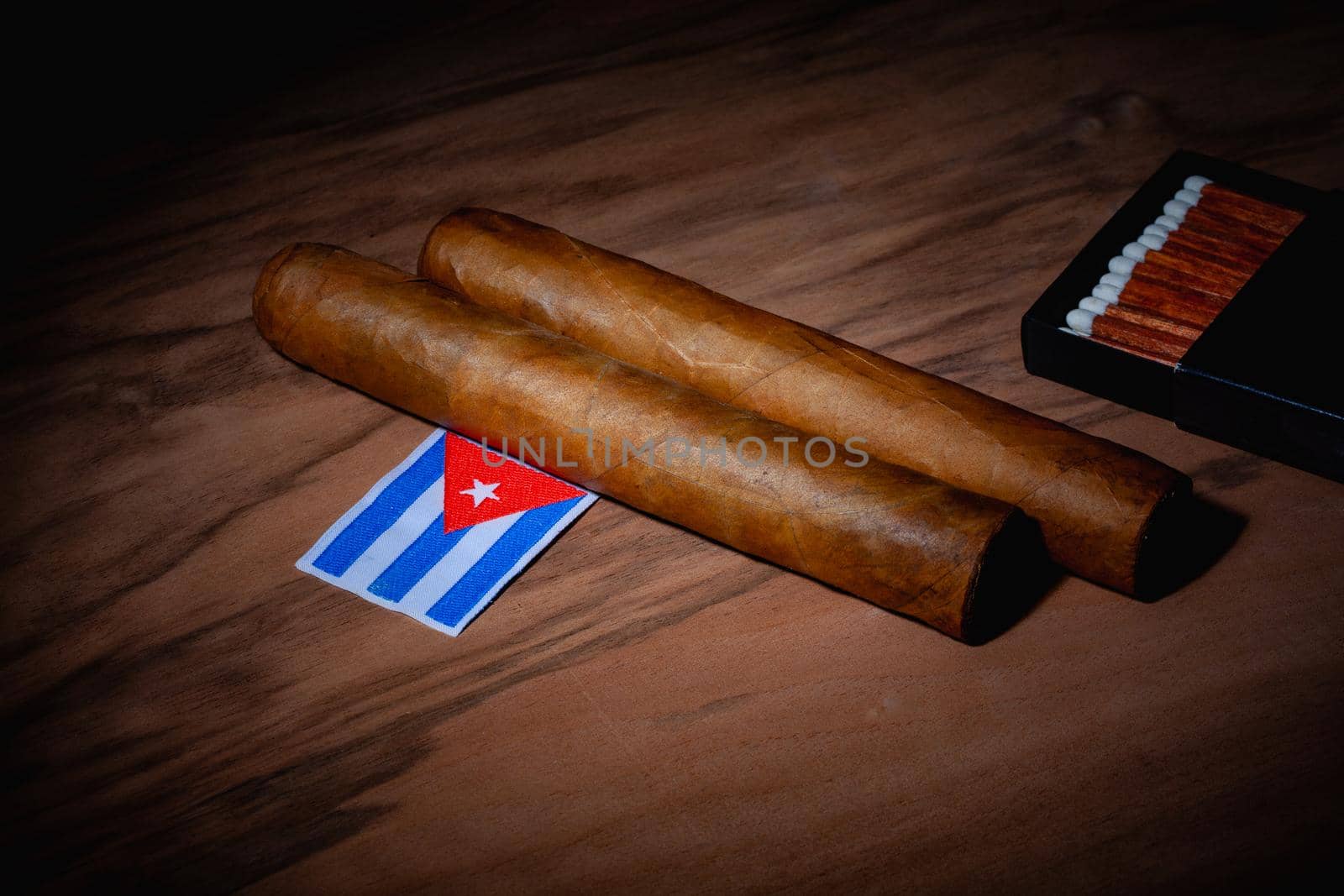 Luxury Cuban cigars and match bow on the wooden desk