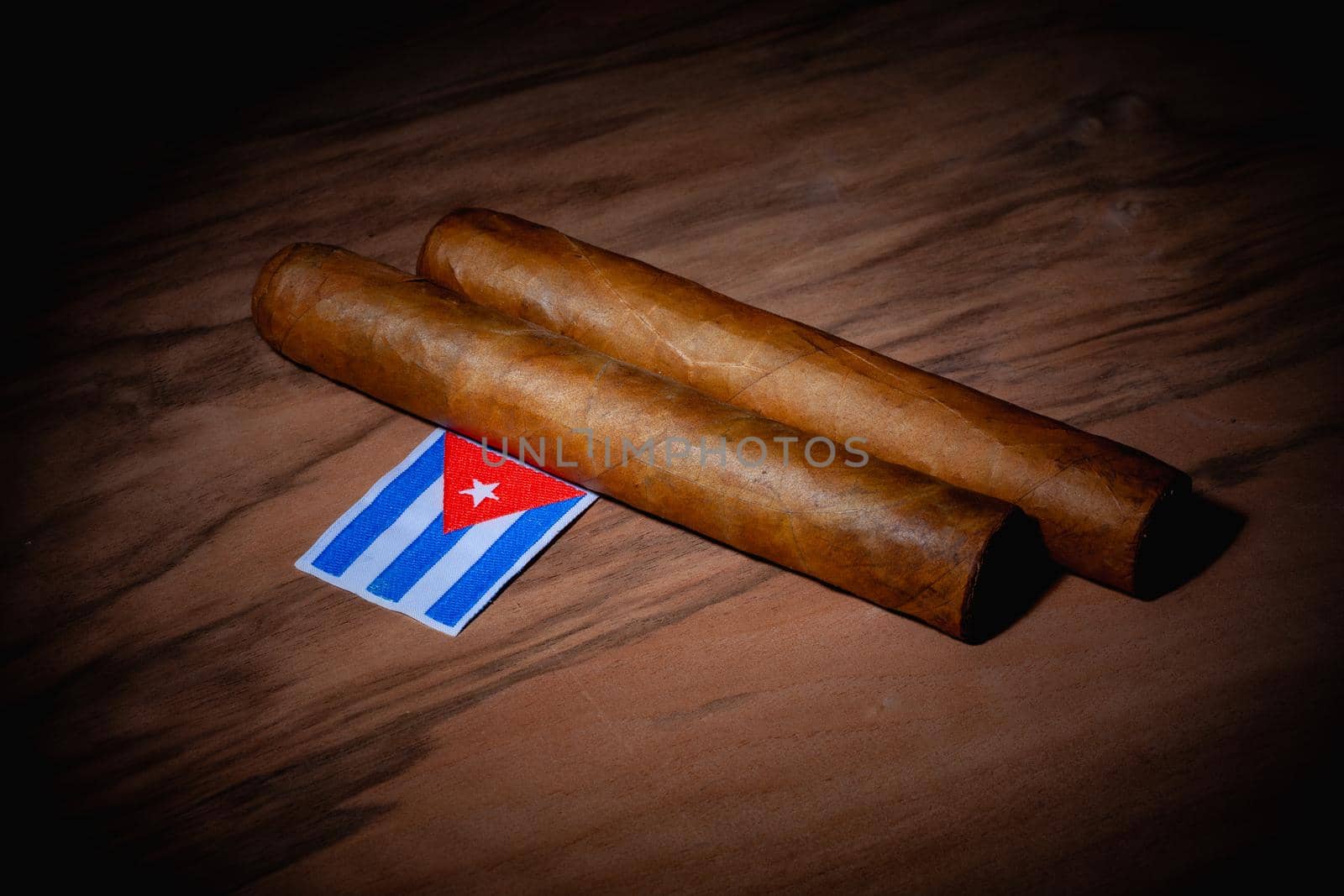 Luxury Cuban cigars and match bow on the wooden desk