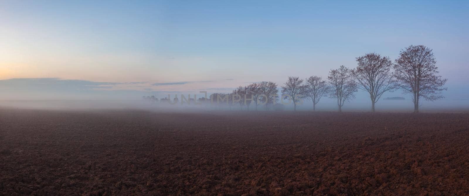Landscape covered with fog in Central Bohemian Uplands, Czech Republic. Misty morning between fields.