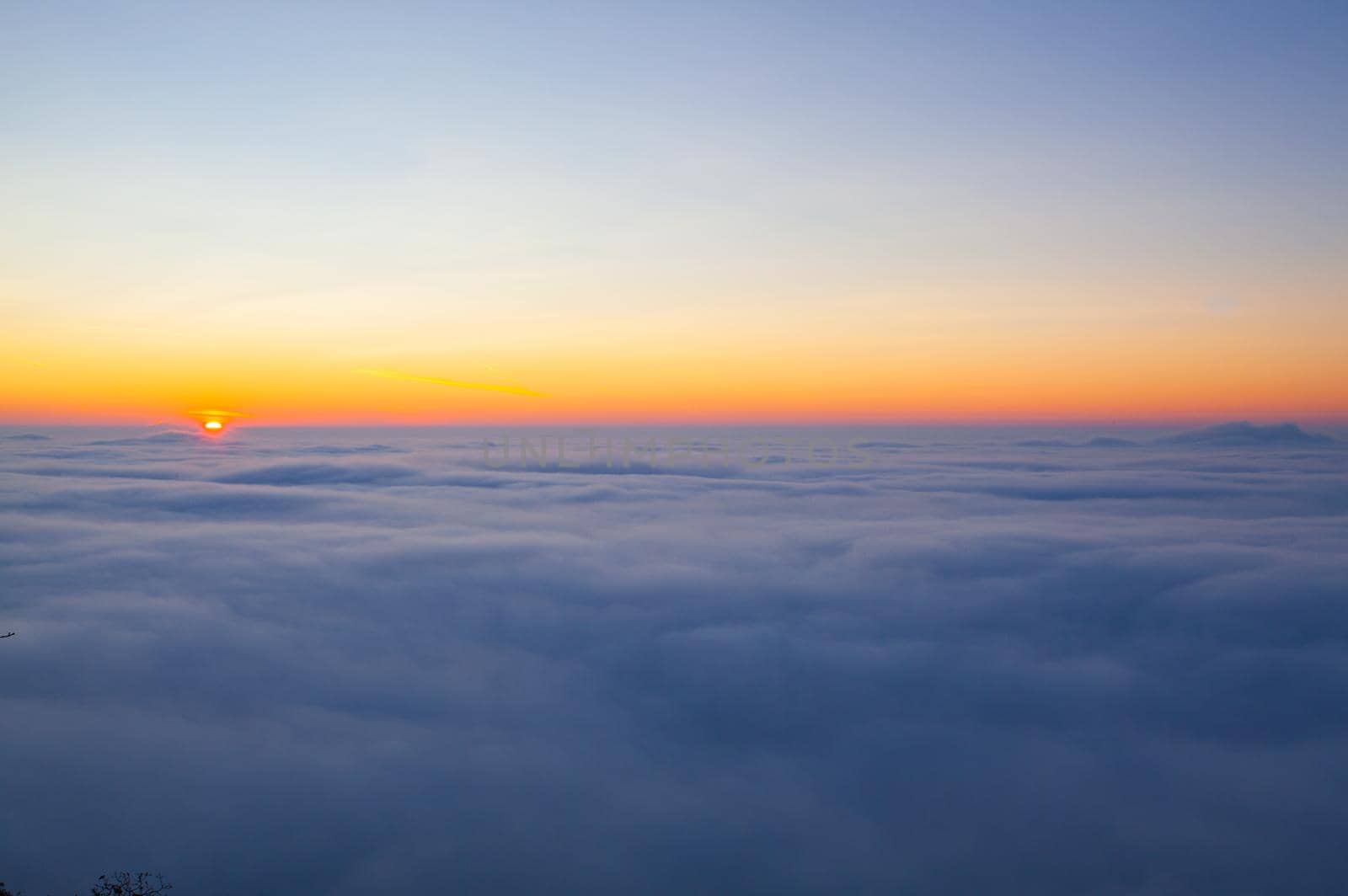 Amazing sunrise above clouds from the top of the mountain in Central Bohemian Uplands, Czech Republic