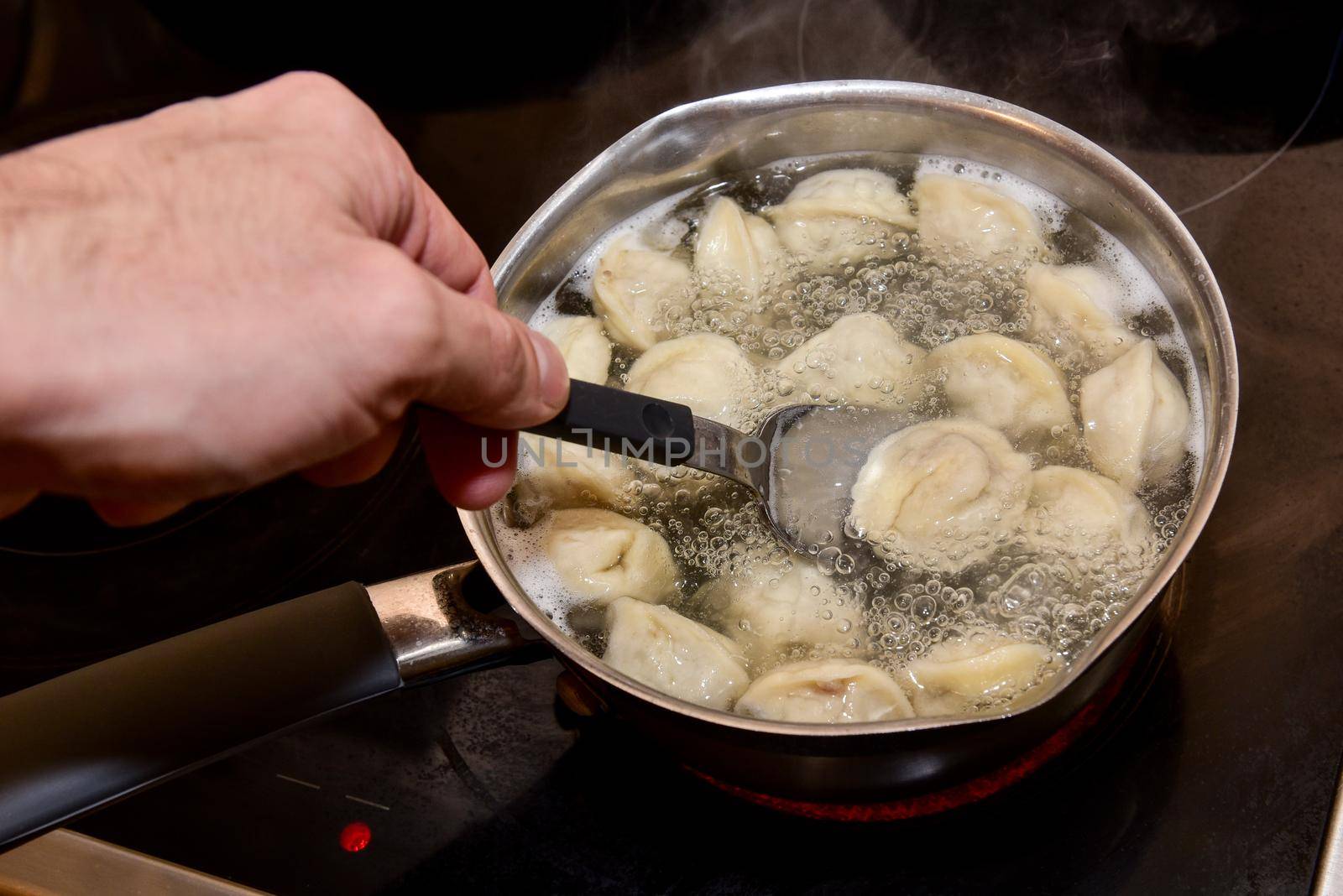 Dumplings in boiling water. Meat dumplings are boiled in a pot of boiling water.