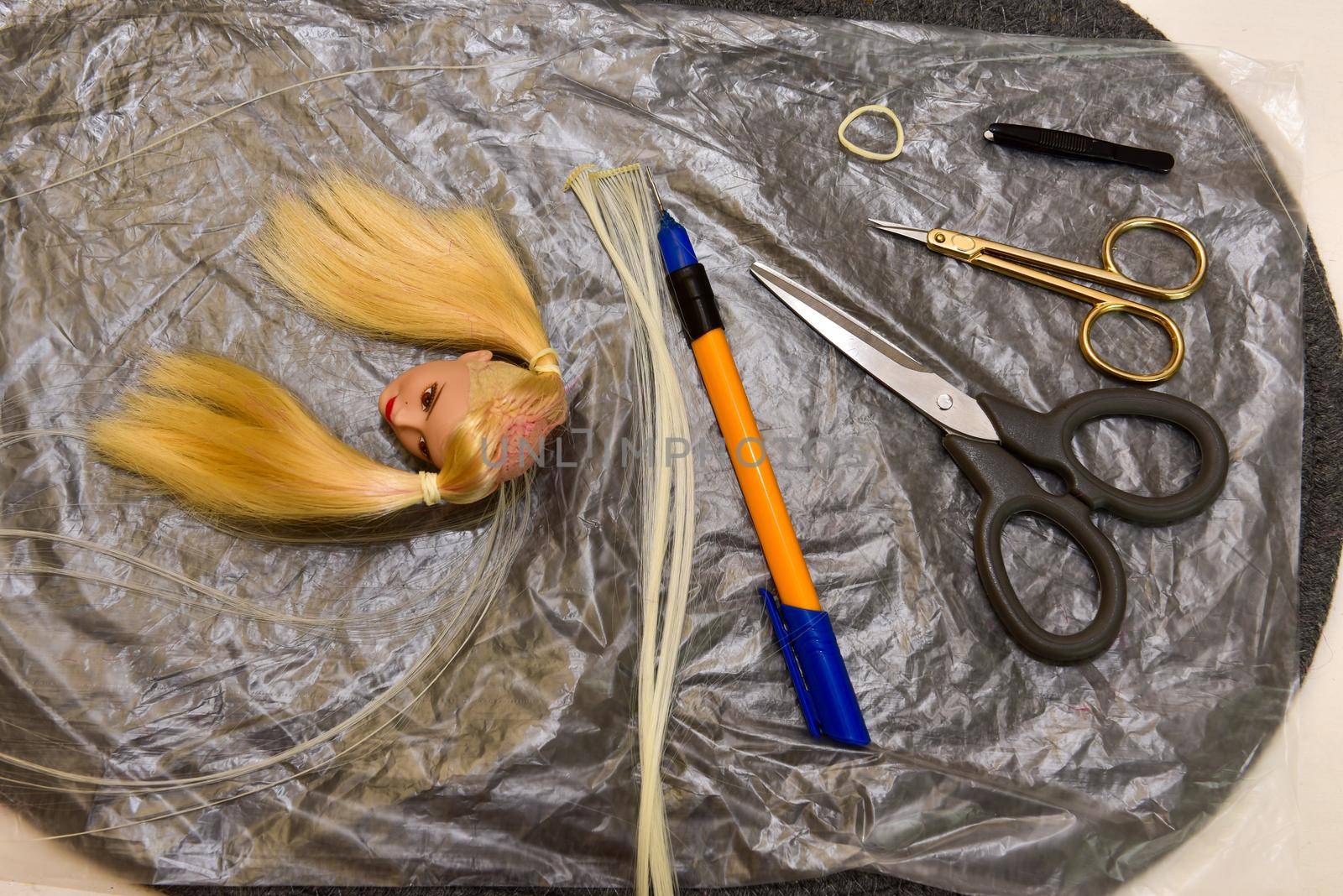 scissors and homemade tool on the table, how to make hair for a doll, hobby concept by karpovkottt