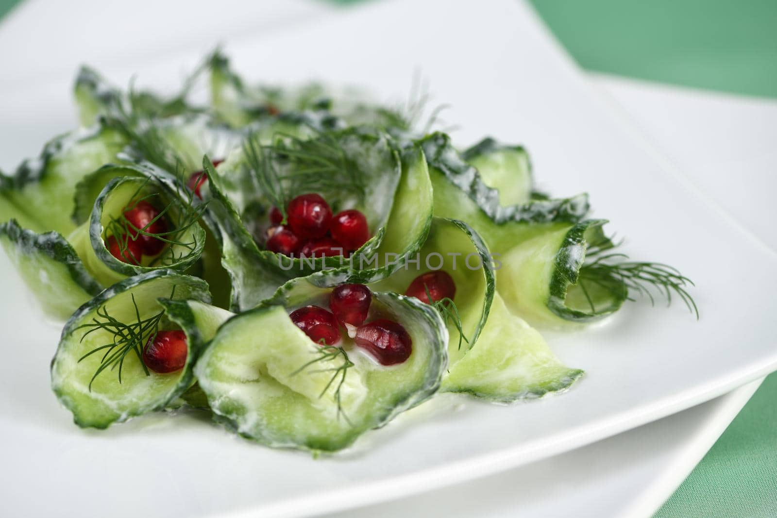 Fresh cucumber salad with dill and pomegranate kernels, in yoghurt sauce