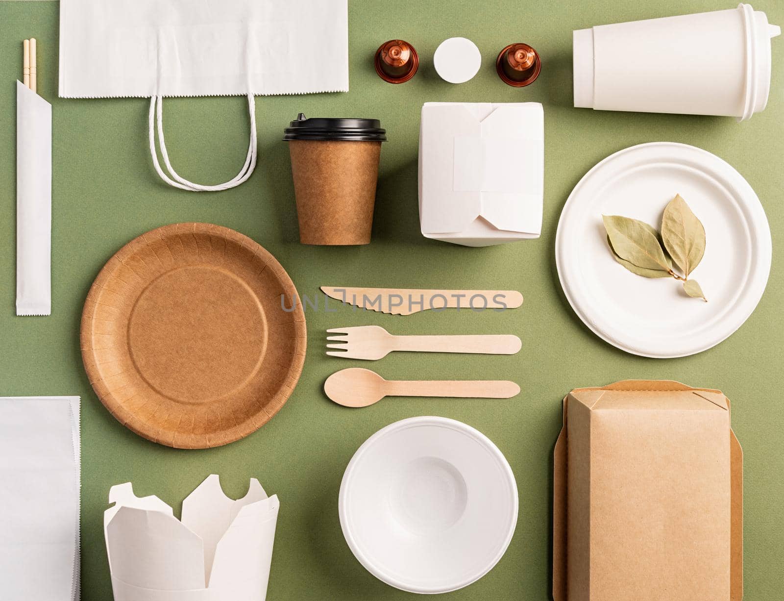 Knolling concept. Eco friendly zero waste disposable tableware top view flat lay on green background. Pattern
