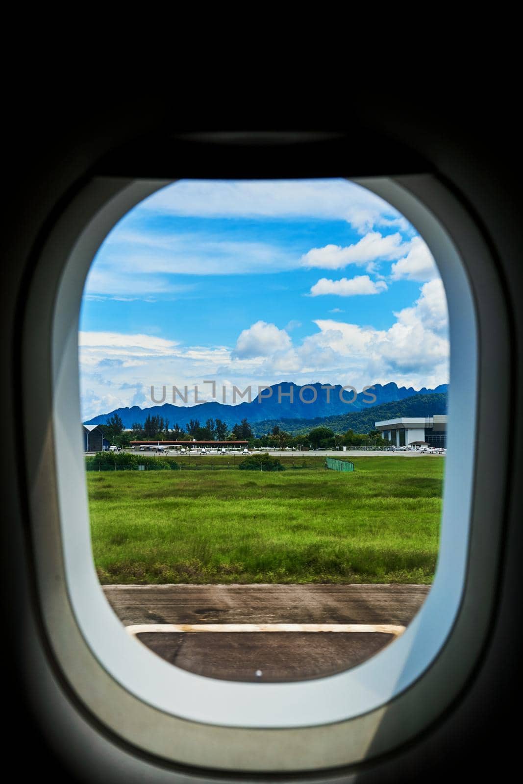 View from the window of an airplane on the runway of a tropical island by Try_my_best