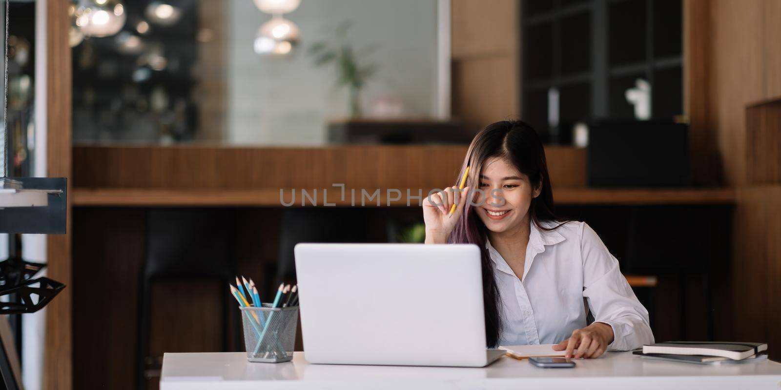 Young asian woman studying online via laptop computer for e-learning - Online Education Concept.