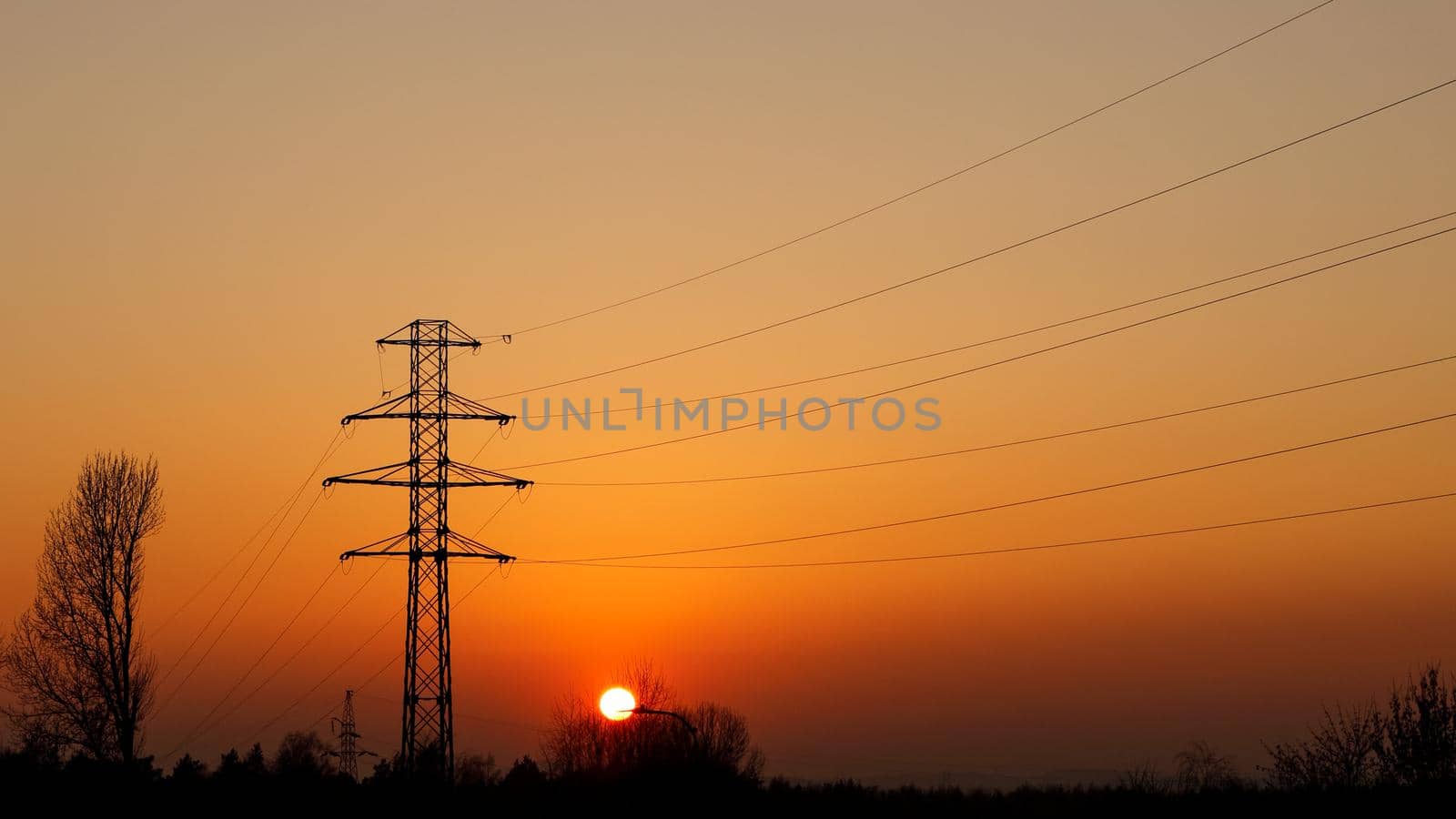 Metal electric pole at sunset