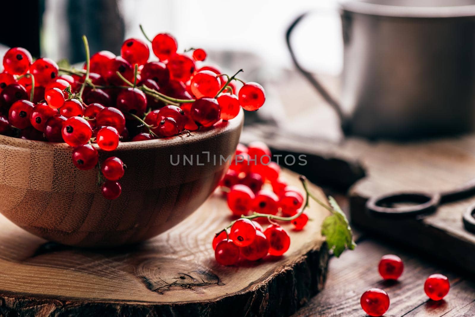 Fresh picked red currants in wooden bowl