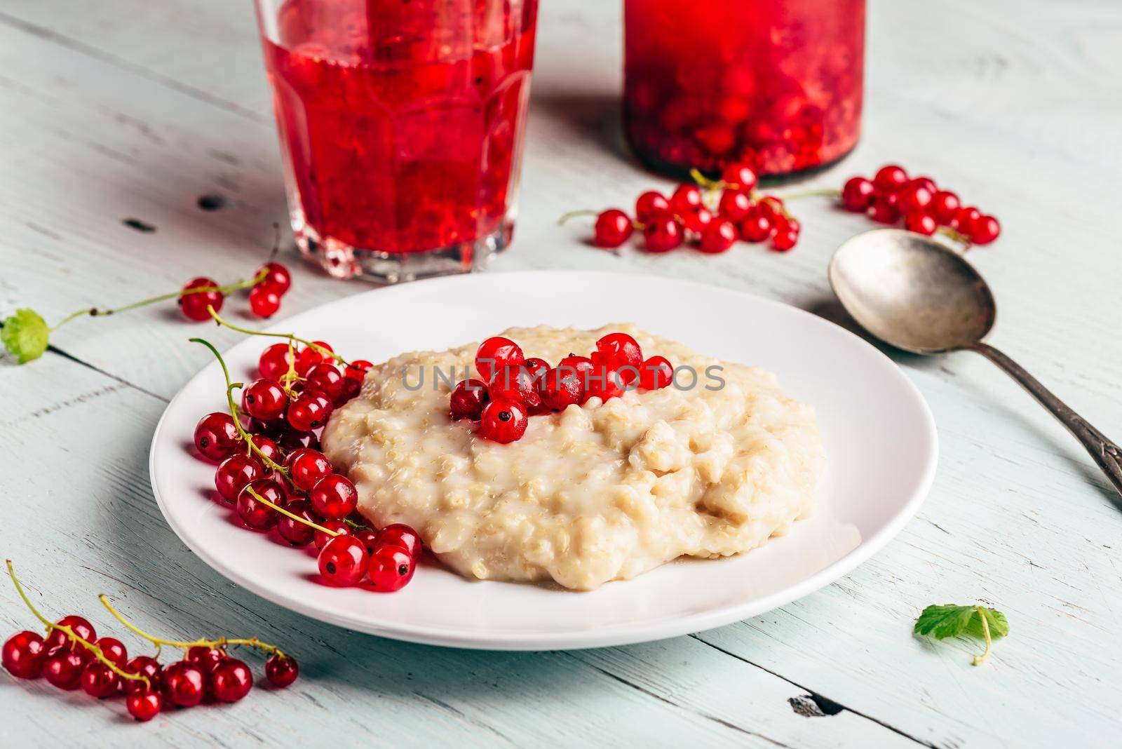 Simple and healthy breakfast with porridge and infused water with berries